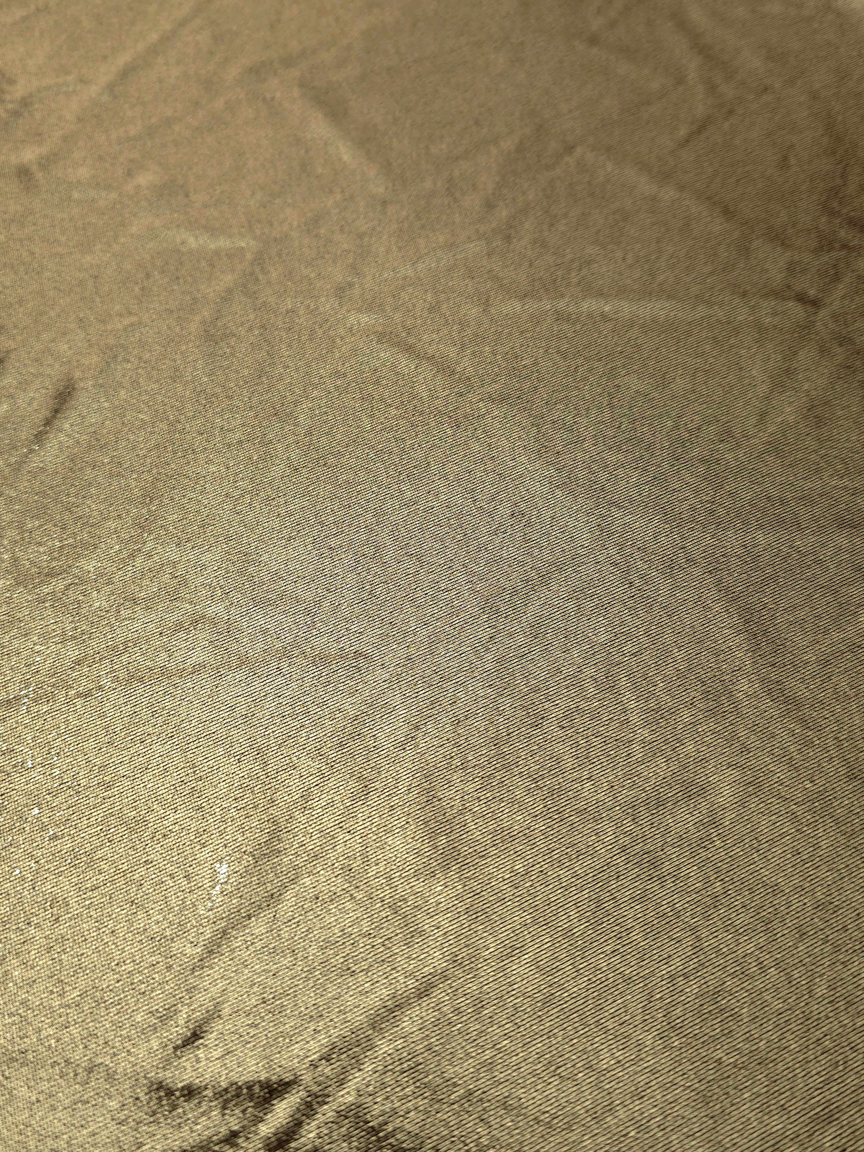 Detailed close-up of Khaki Taupe foiled spandex fabric showing its luminous metallic surface and fine reflective texture