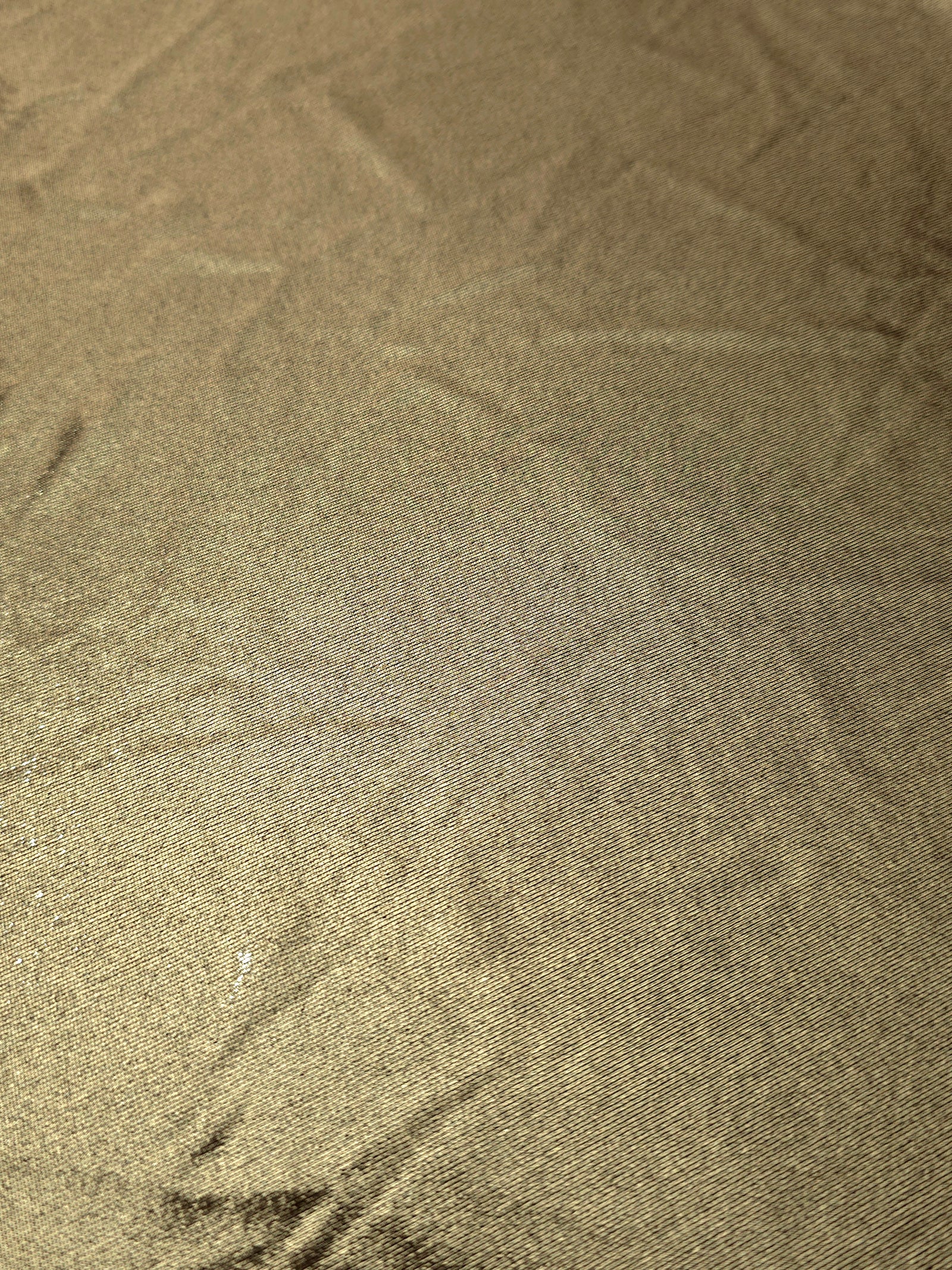 Detailed close-up of Khaki Taupe foiled spandex fabric showing its luminous metallic surface and fine reflective texture