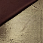 Khaki Taupe foiled stretch fabric in a gentle fold, showing metallic shimmer and flexibility for partywear and performance fashion