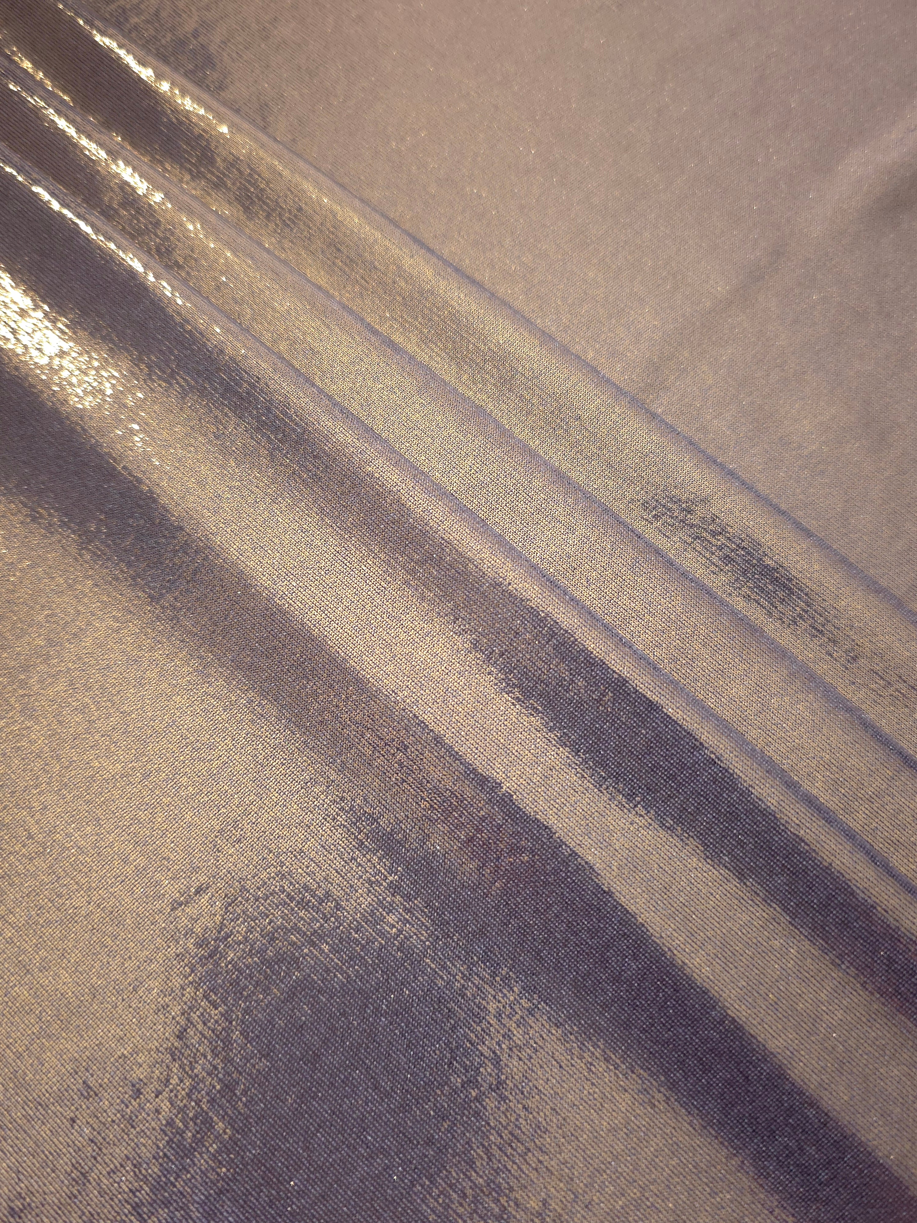 Layered folds of Lavender Taupe foiled stretch fabric showing shimmer, body and movement for performance outfits and statement garments