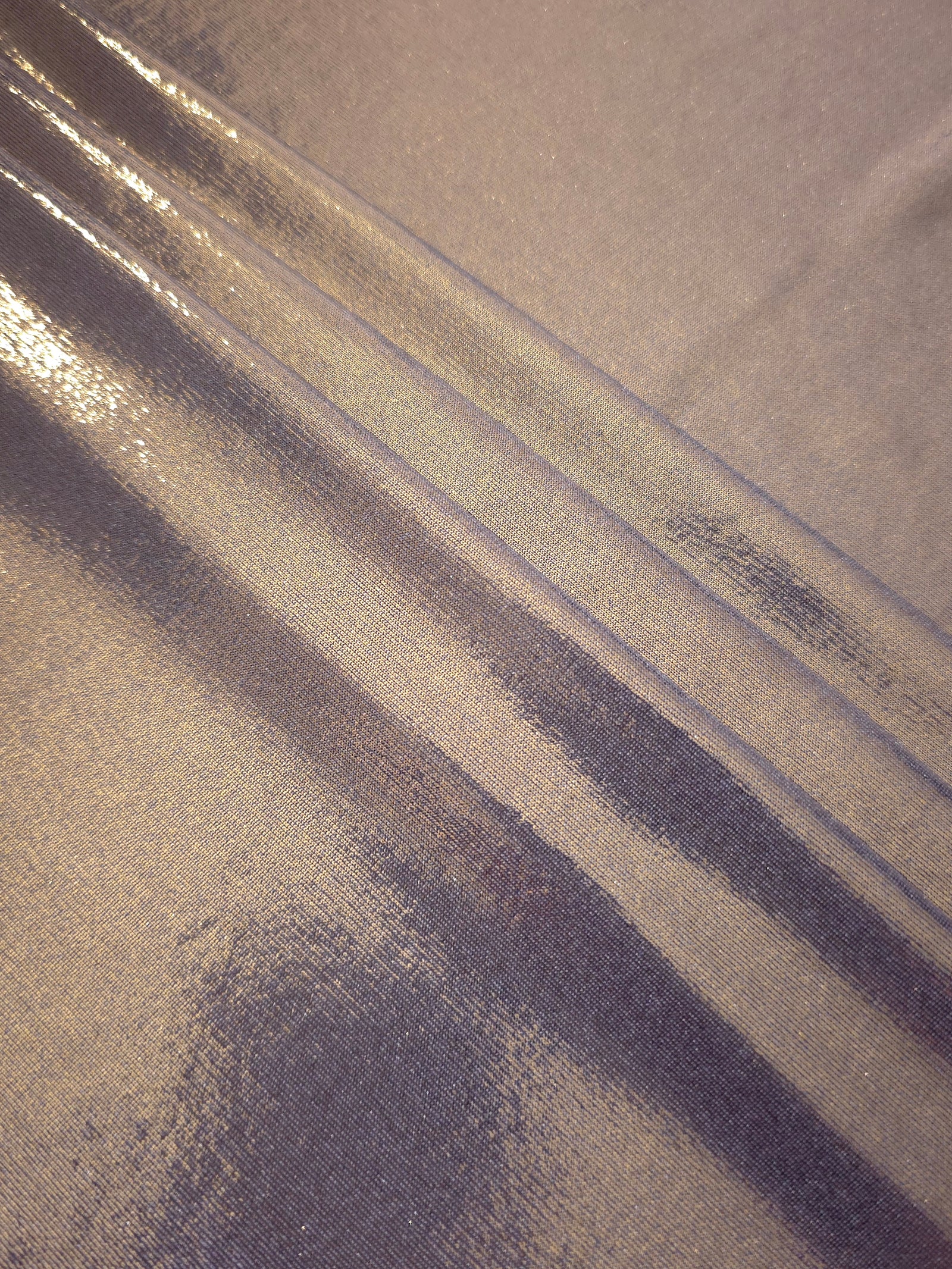 Layered folds of Lavender Taupe foiled stretch fabric showing shimmer, body and movement for performance outfits and statement garments