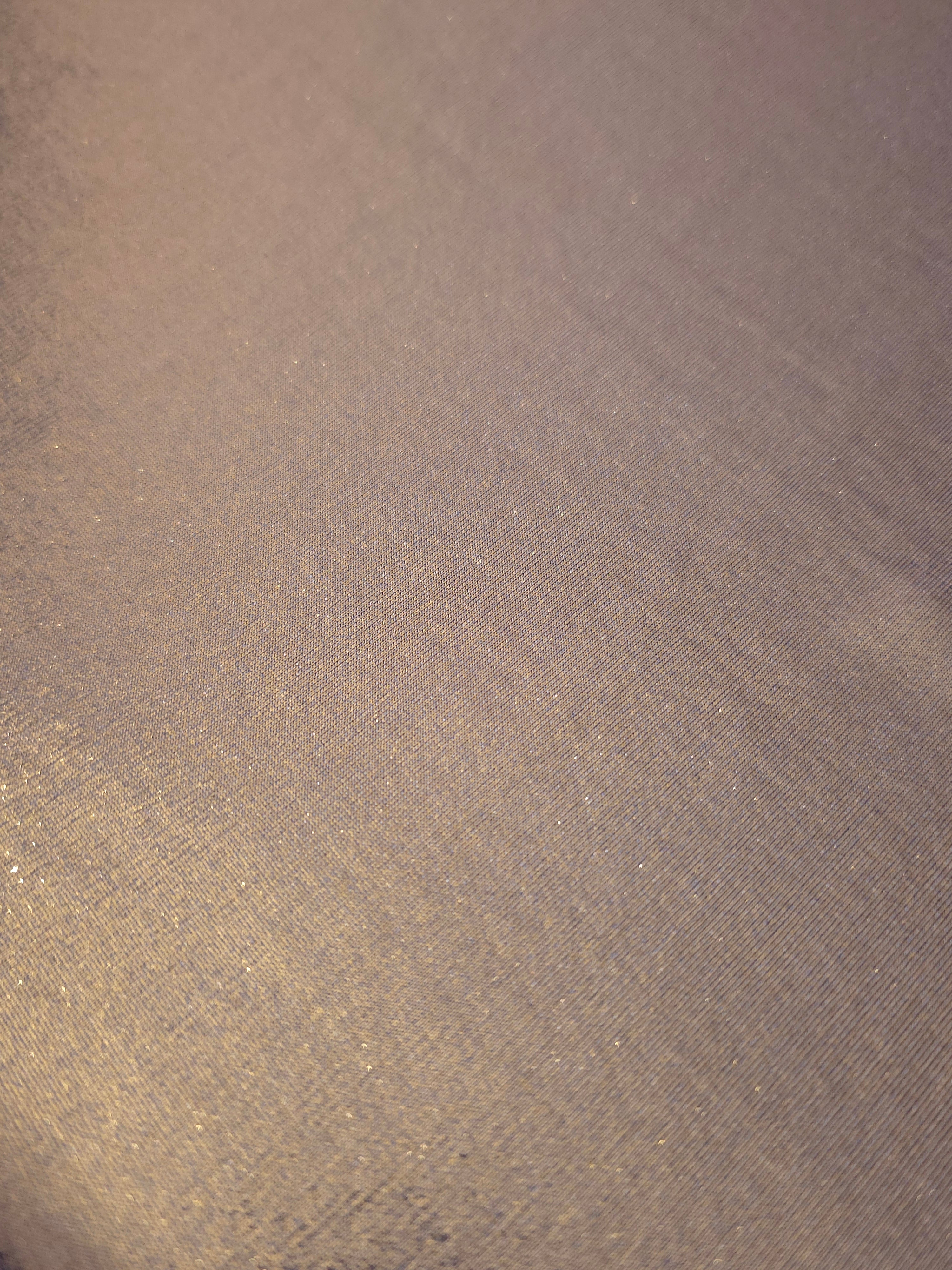 Detailed close-up of Lavender Taupe foiled spandex fabric showing its luminous metallic surface and fine reflective texture