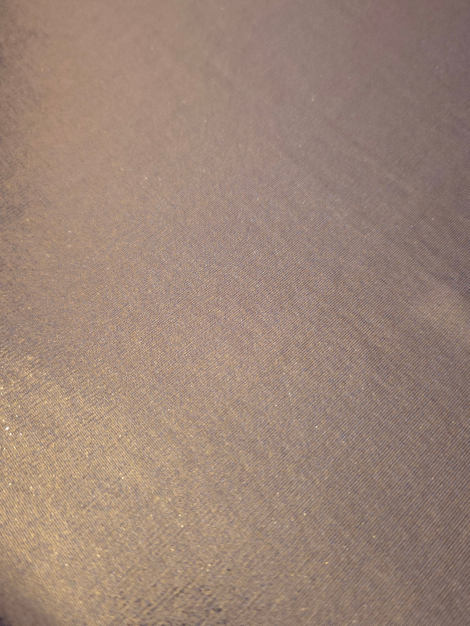 Detailed close-up of Lavender Taupe foiled spandex fabric showing its luminous metallic surface and fine reflective texture