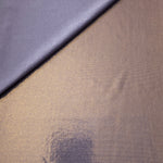 Lavender Taupe foiled stretch fabric in a gentle fold, showing metallic shimmer and flexibility for partywear and performance fashion