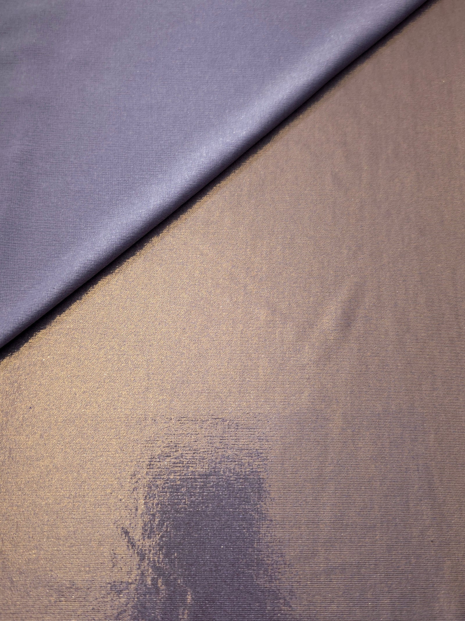Lavender Taupe foiled stretch fabric in a gentle fold, showing metallic shimmer and flexibility for partywear and performance fashion