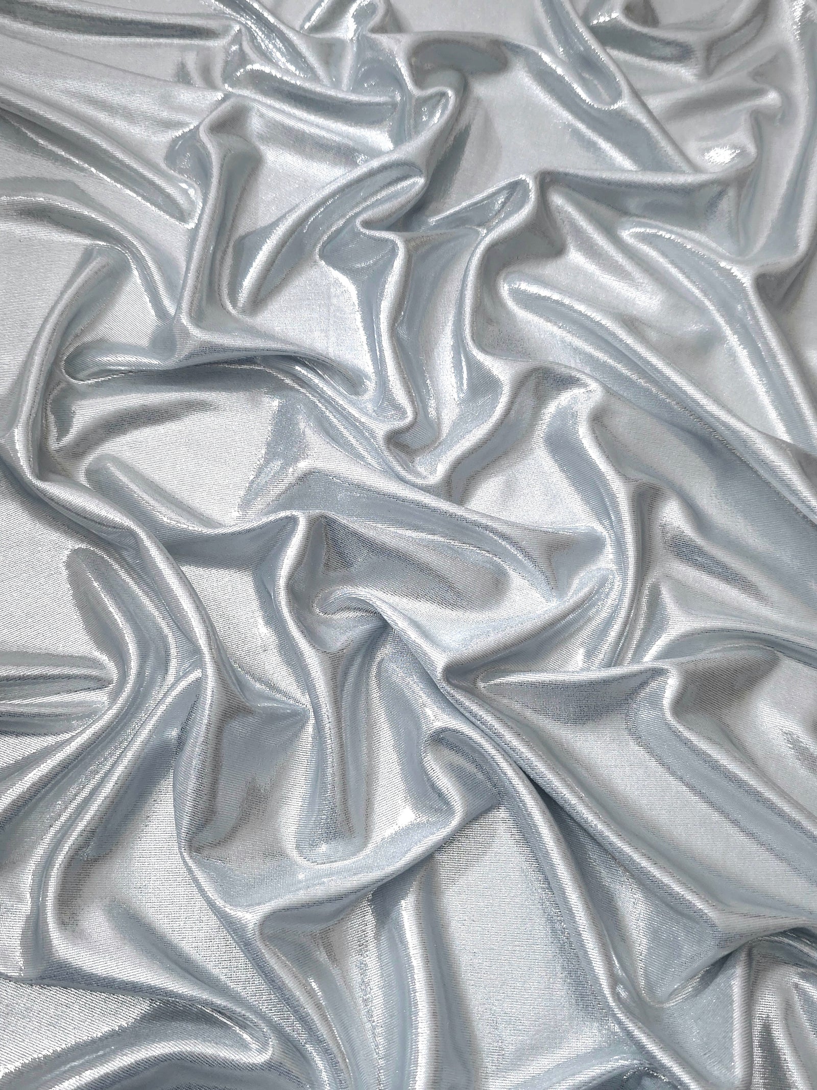Softly draped Light Silver Gray foiled spandex fabric showing fluid shape and metallic shimmer for dresses, stage costumes and eventwear