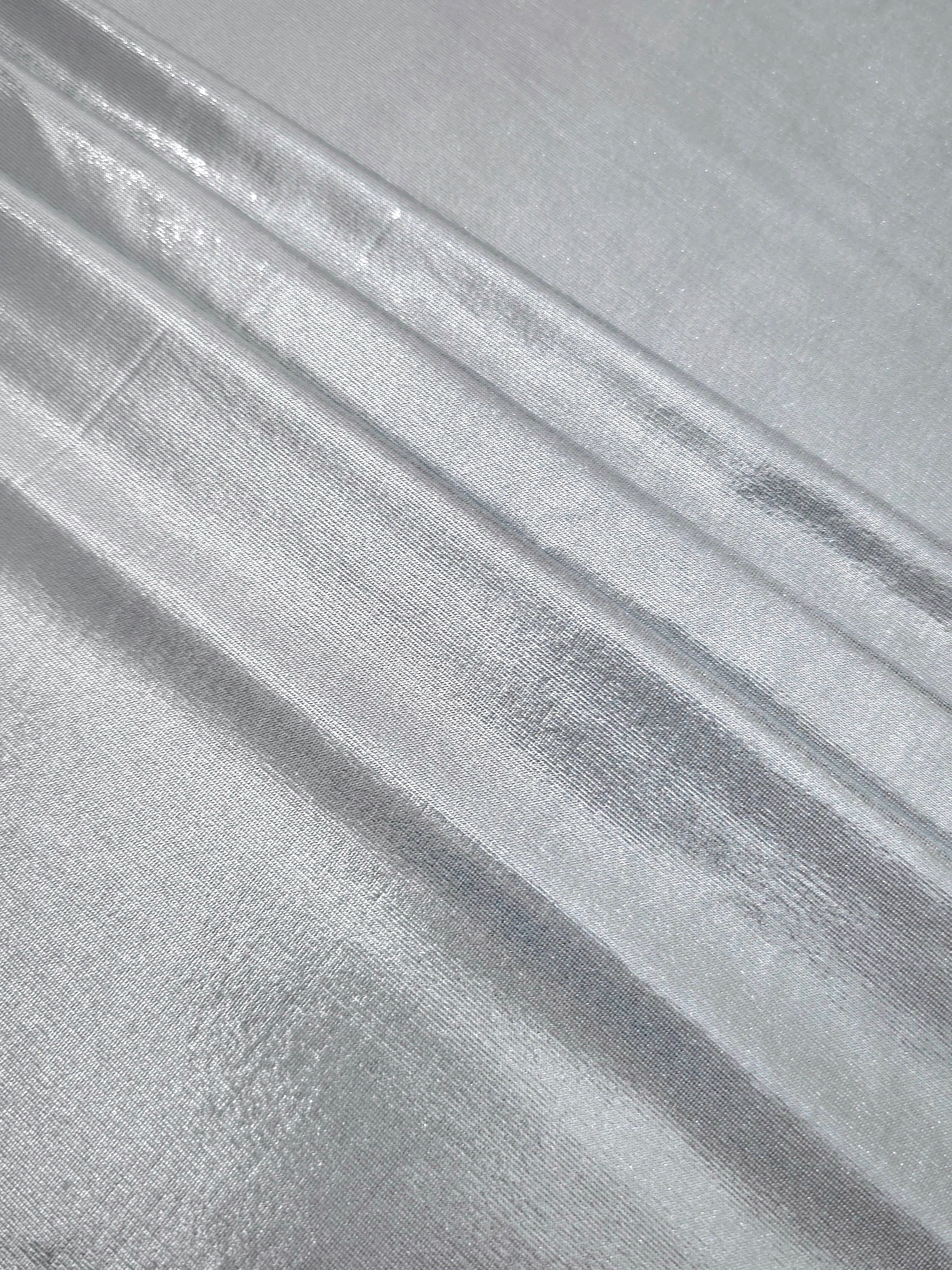 Light Silver Gray foiled spandex arranged in layered folds, displaying shimmer and soft structure for skirts, tops and performancewear