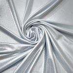 Flowing swirl of Light Silver Gray metallic stretch fabric, showing dynamic foil reflection for stagewear, skirts and creative fashion