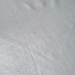 Light Silver Gray foiled stretch fabric texture close-up, displaying metallic reflection and fine surface character for apparel design