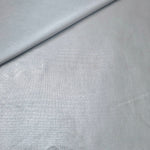 Softly folded Light Silver Gray foiled spandex showing metallic shine and flexible hand for costumes, eveningwear and creative sewing
