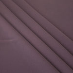 Layered folds of Mauve Taupe 100% mechanical polyester crepe showing body and gentle construction stretch