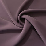 Mauve Taupe opaque polyester crepe in a spiral drape, showing flowing form for skirts and modest garments