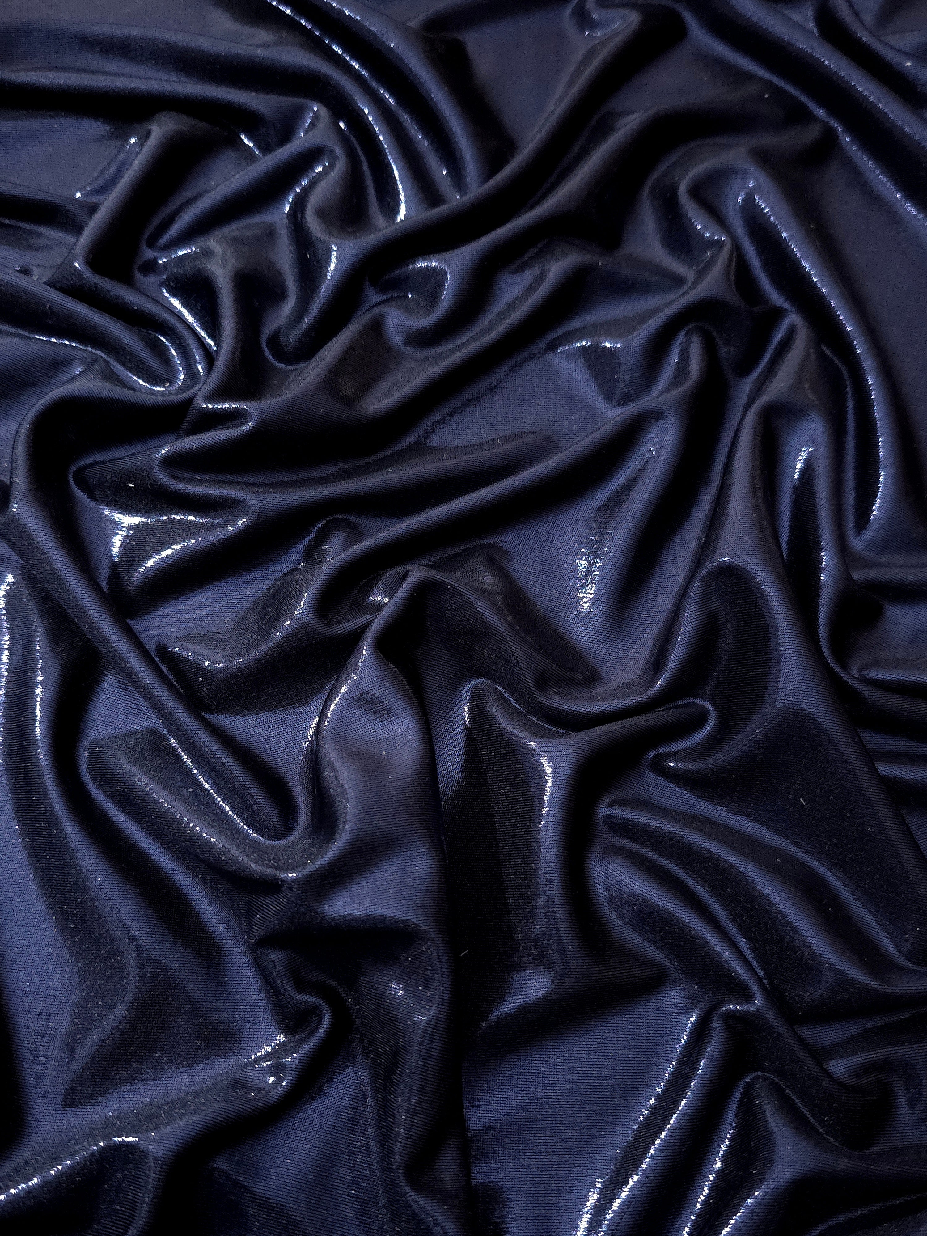 Midnight Navy Blue shimmer stretch fabric in draped folds, highlighting metallic foil sheen for evening dresses, costumes and statement apparel
