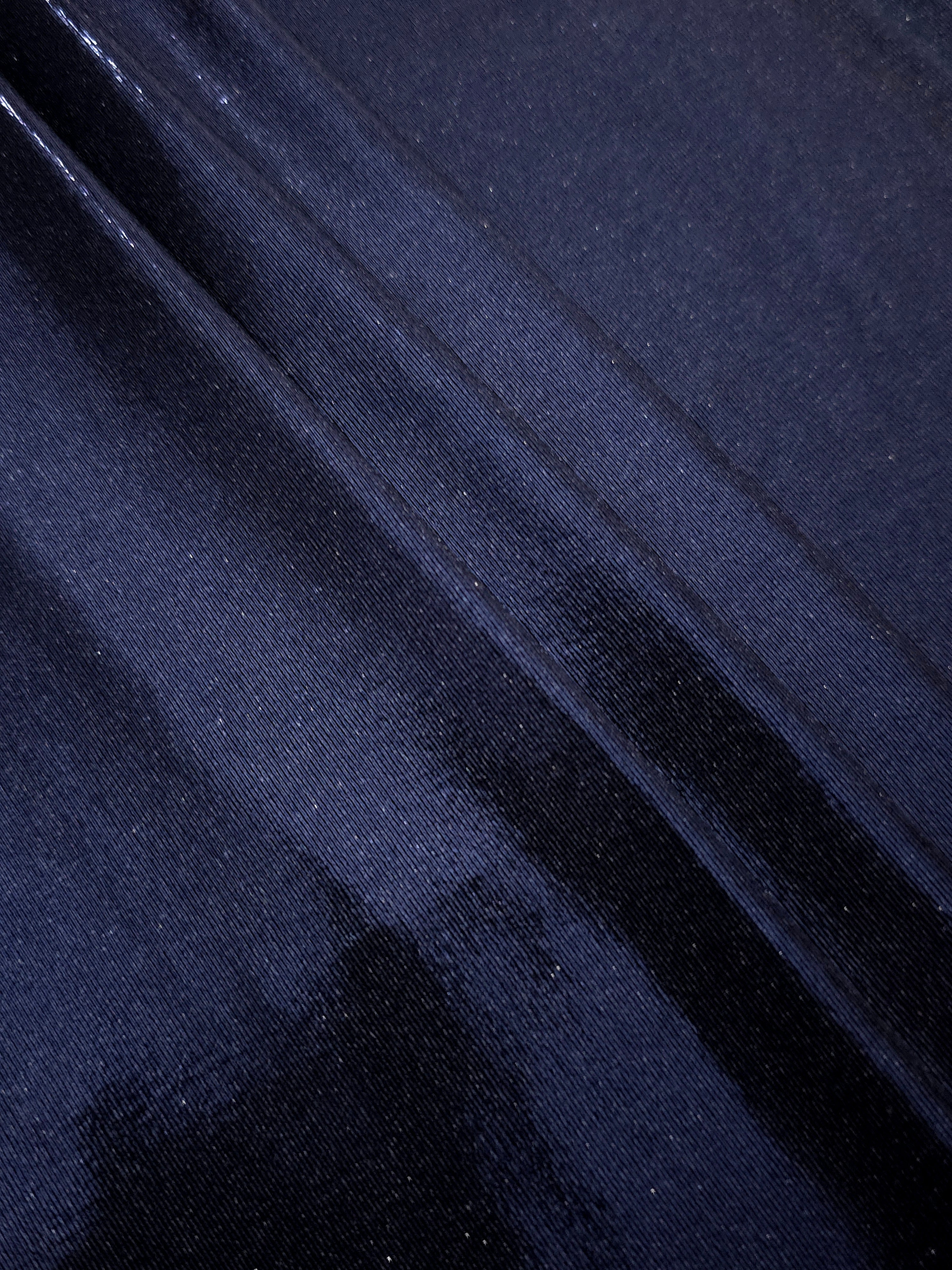 Midnight Navy Blue metallic foiled spandex in layered folds, highlighting reflective texture and flexible structure for stage and eveningwear