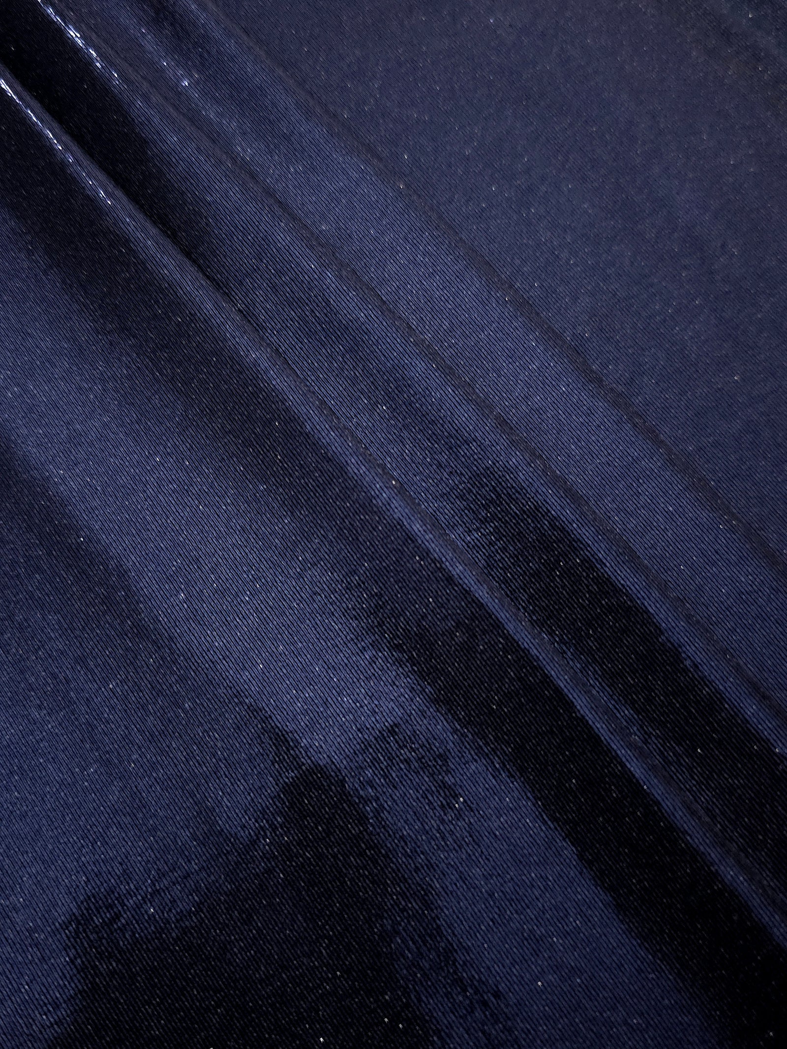 Midnight Navy Blue metallic foiled spandex in layered folds, highlighting reflective texture and flexible structure for stage and eveningwear