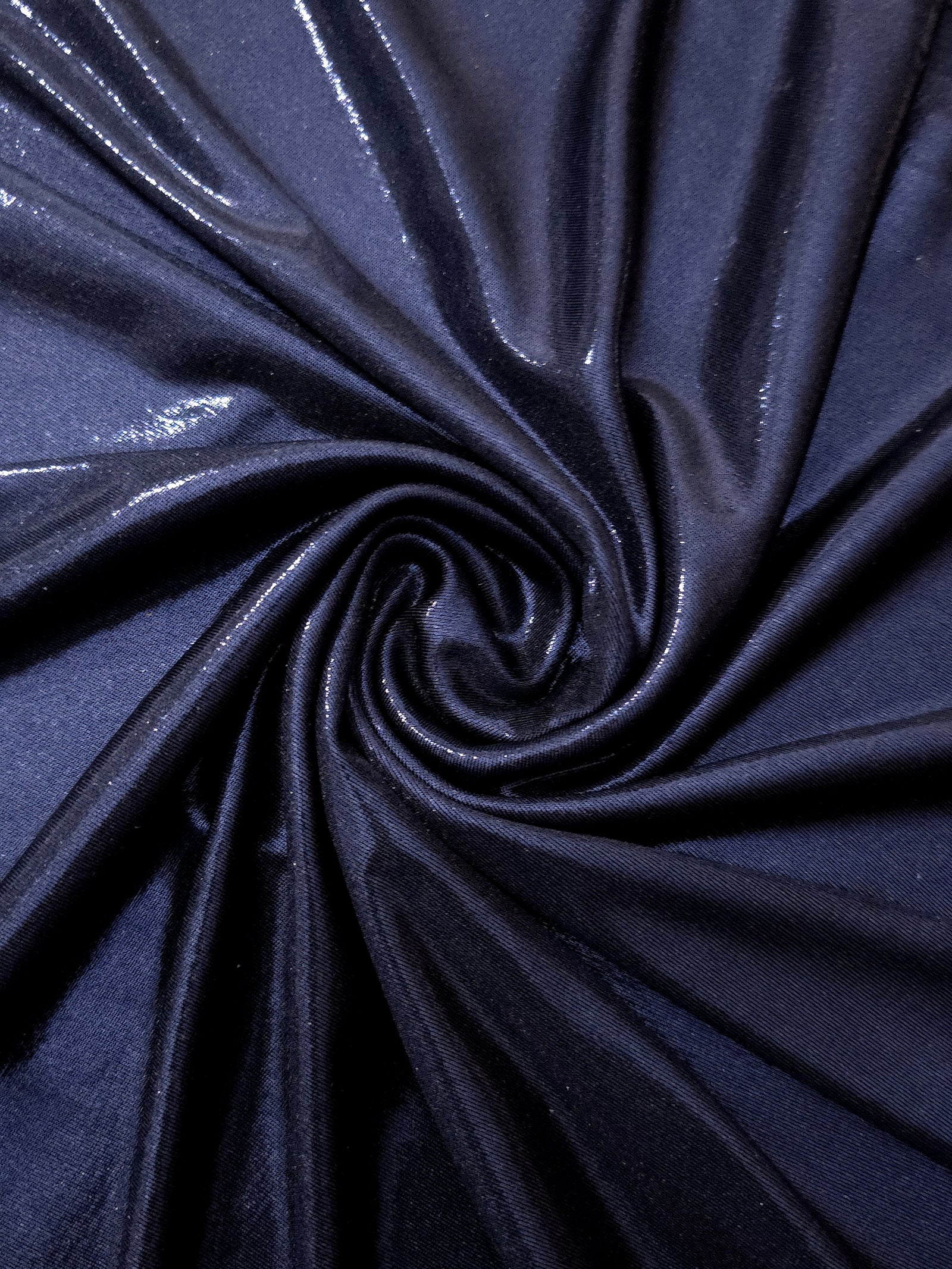 Swirled Midnight Navy Blue metallic foiled spandex showing fluid movement and luminous sheen for dresses, dancewear and stage costumes