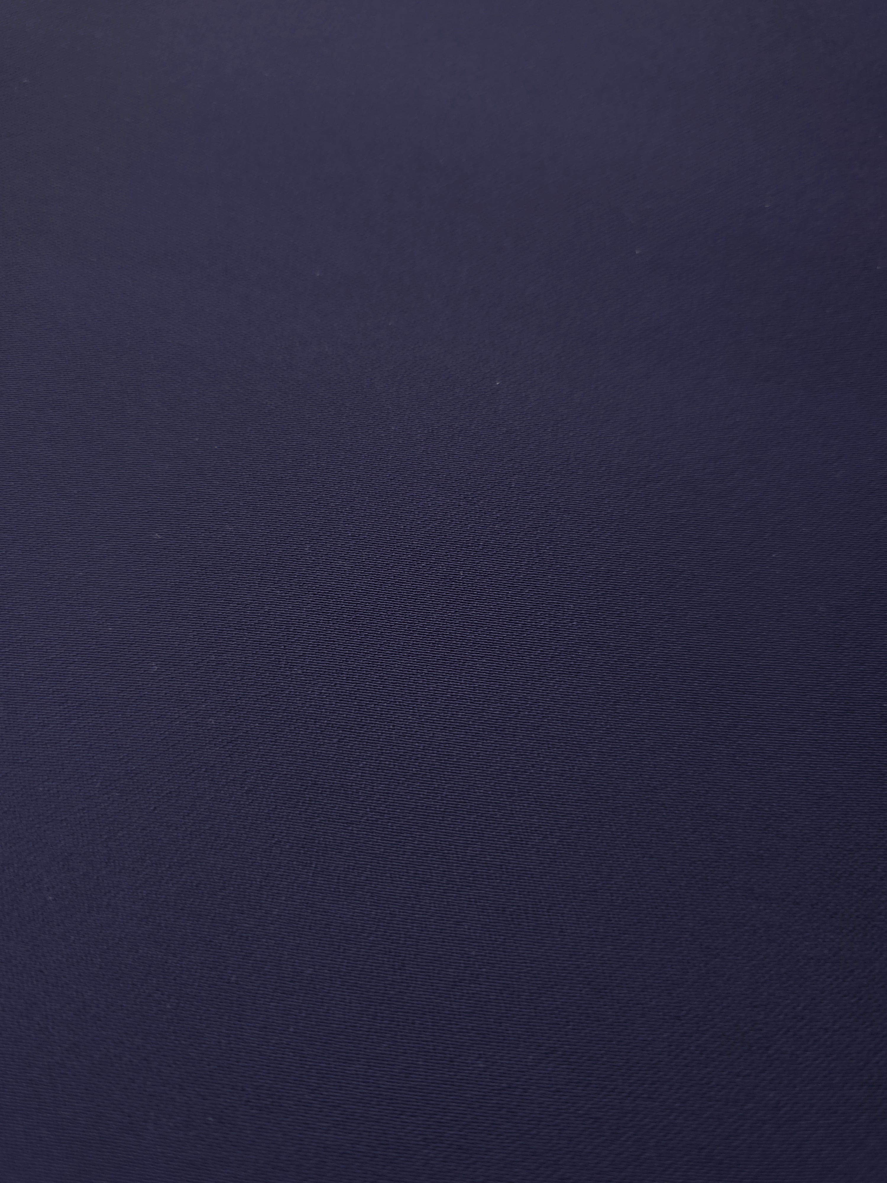 Close-up of Midnight Navy Purple mechanical polyester crepe showing fine woven texture and a smooth silky-soft hand