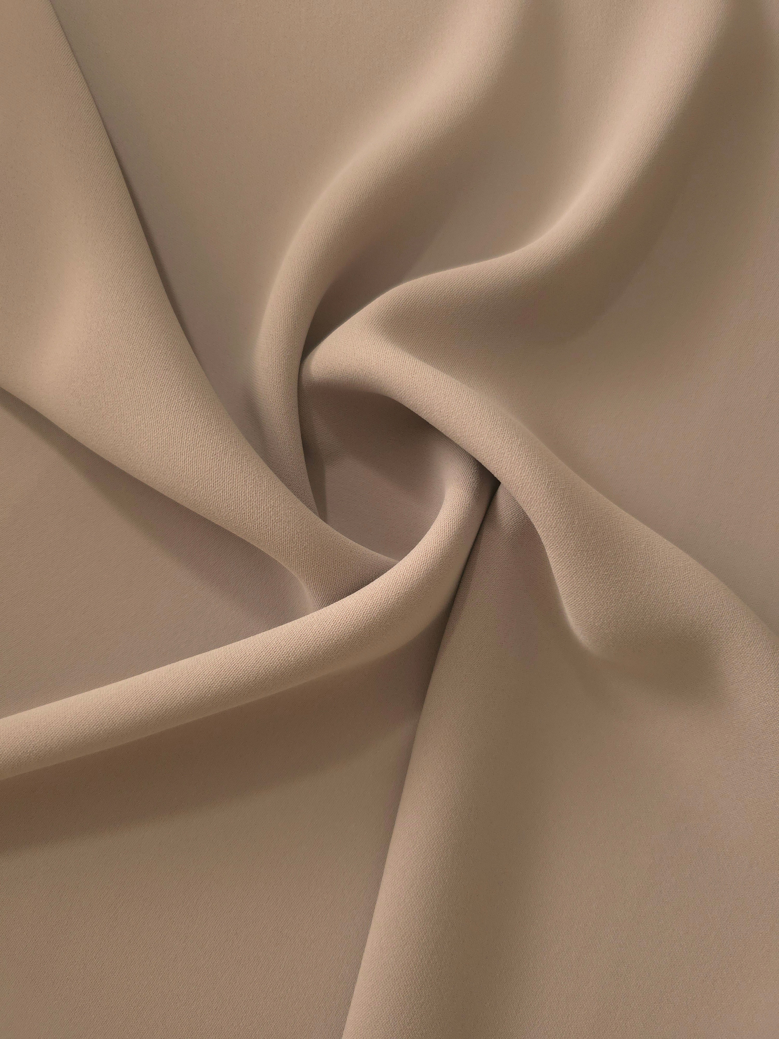 Swirled Mocha Taupe polyester crepe showing supple movement and soft drape for dresses and occasionwear
