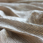 Close-up of Moonlight gold pleated stretch tulle fabric with silver foil shimmer texture