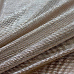 Moonlight gold stretch tulle fabric with silver foil shown in a soft draped view