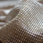 Close-up of Moonlight gold sheer shimmer tulle fabric with silver square foil texture