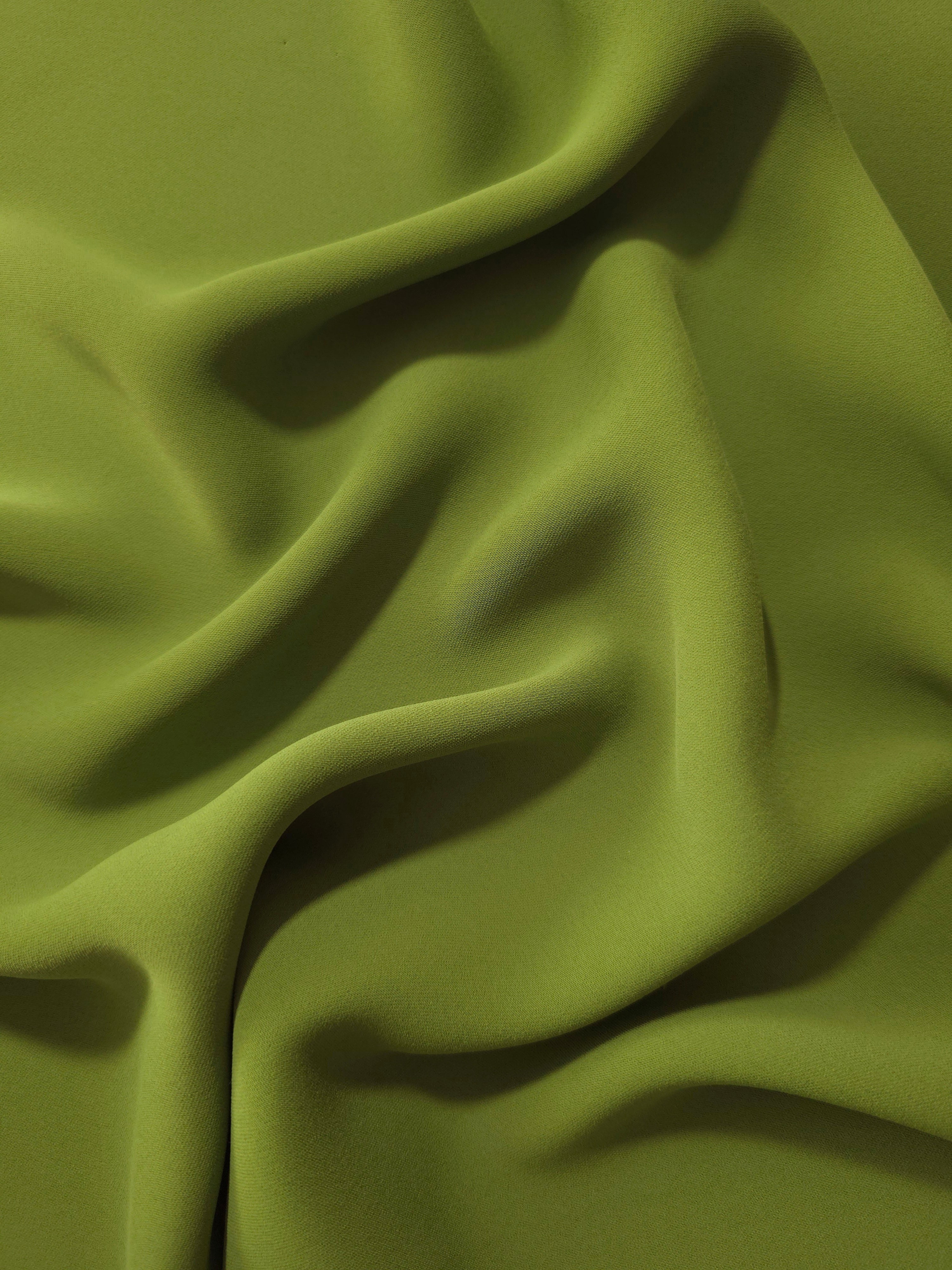 Fluid folds of Moss Green opaque Korean crepe, a dress fabric suited to eveningwear and flowing skirts