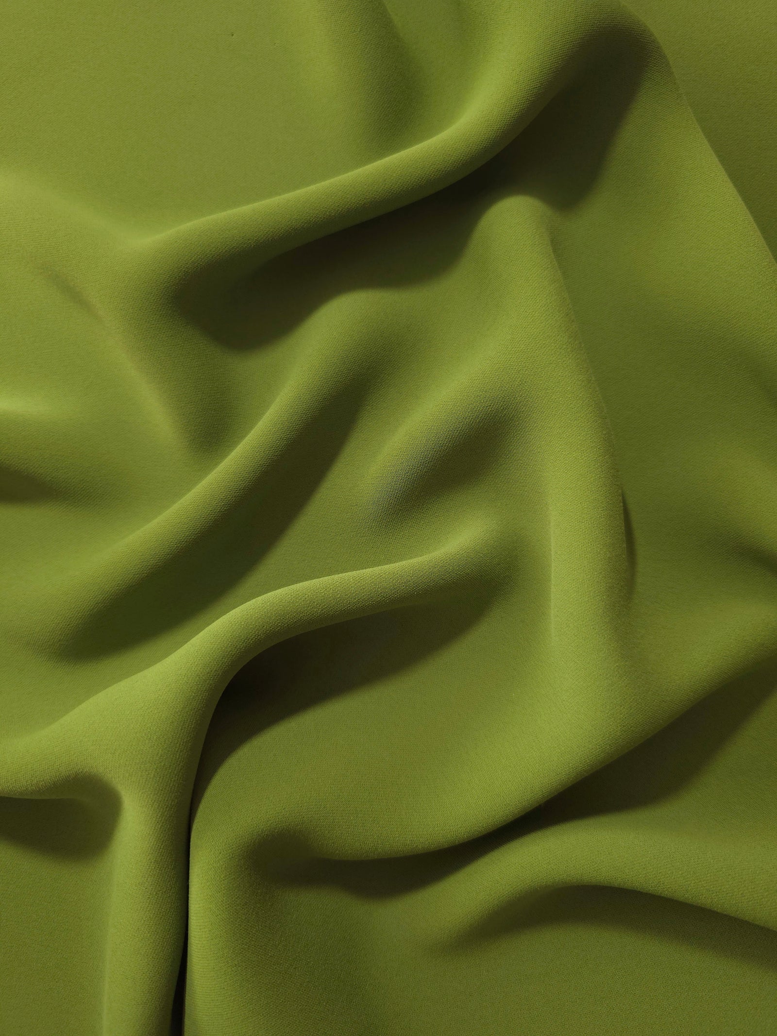 Fluid folds of Moss Green opaque Korean crepe, a dress fabric suited to eveningwear and flowing skirts