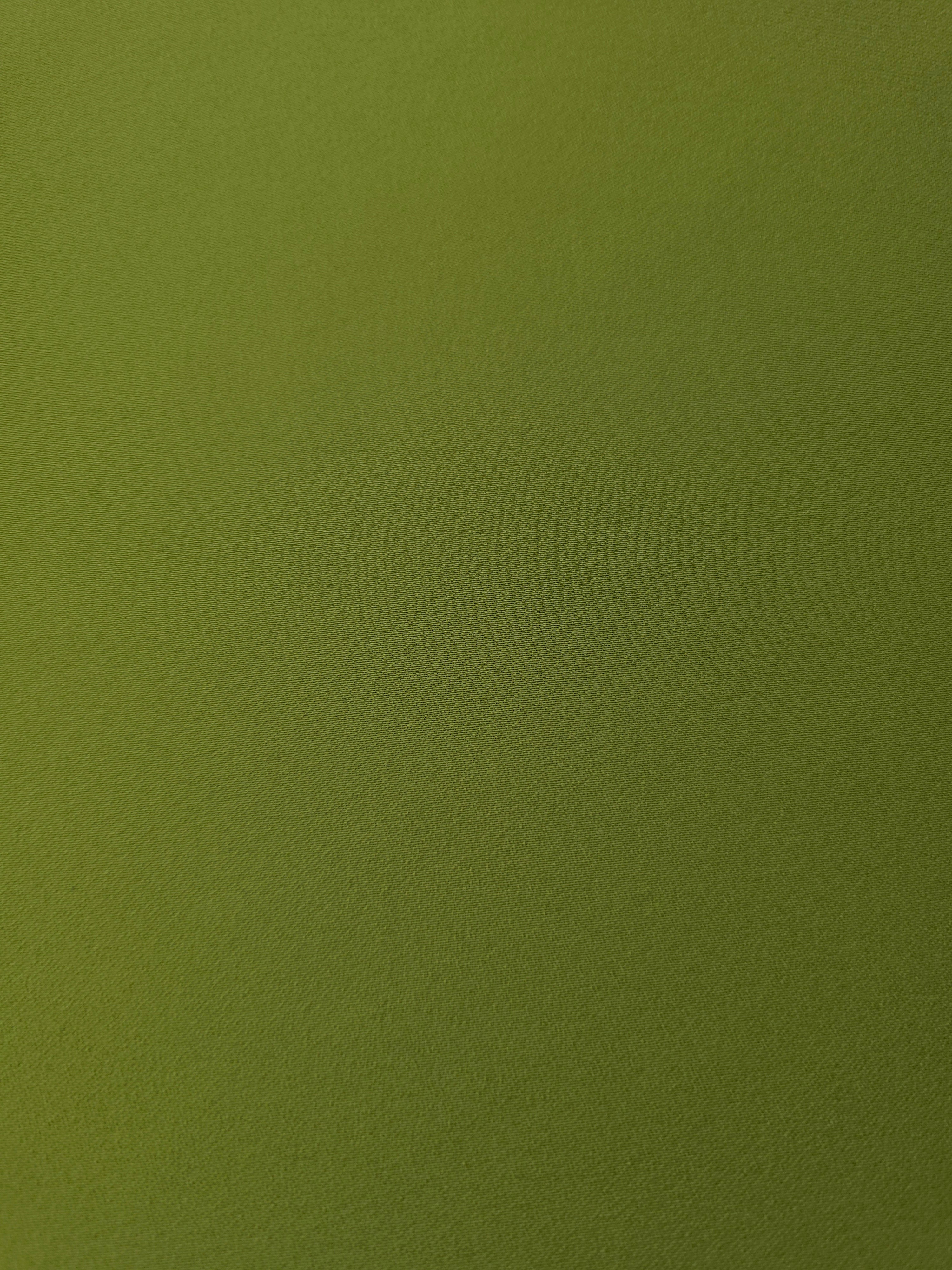 Texture detail of Moss Green mechanical polyester crepe, a smooth woven fabric with a soft silky hand