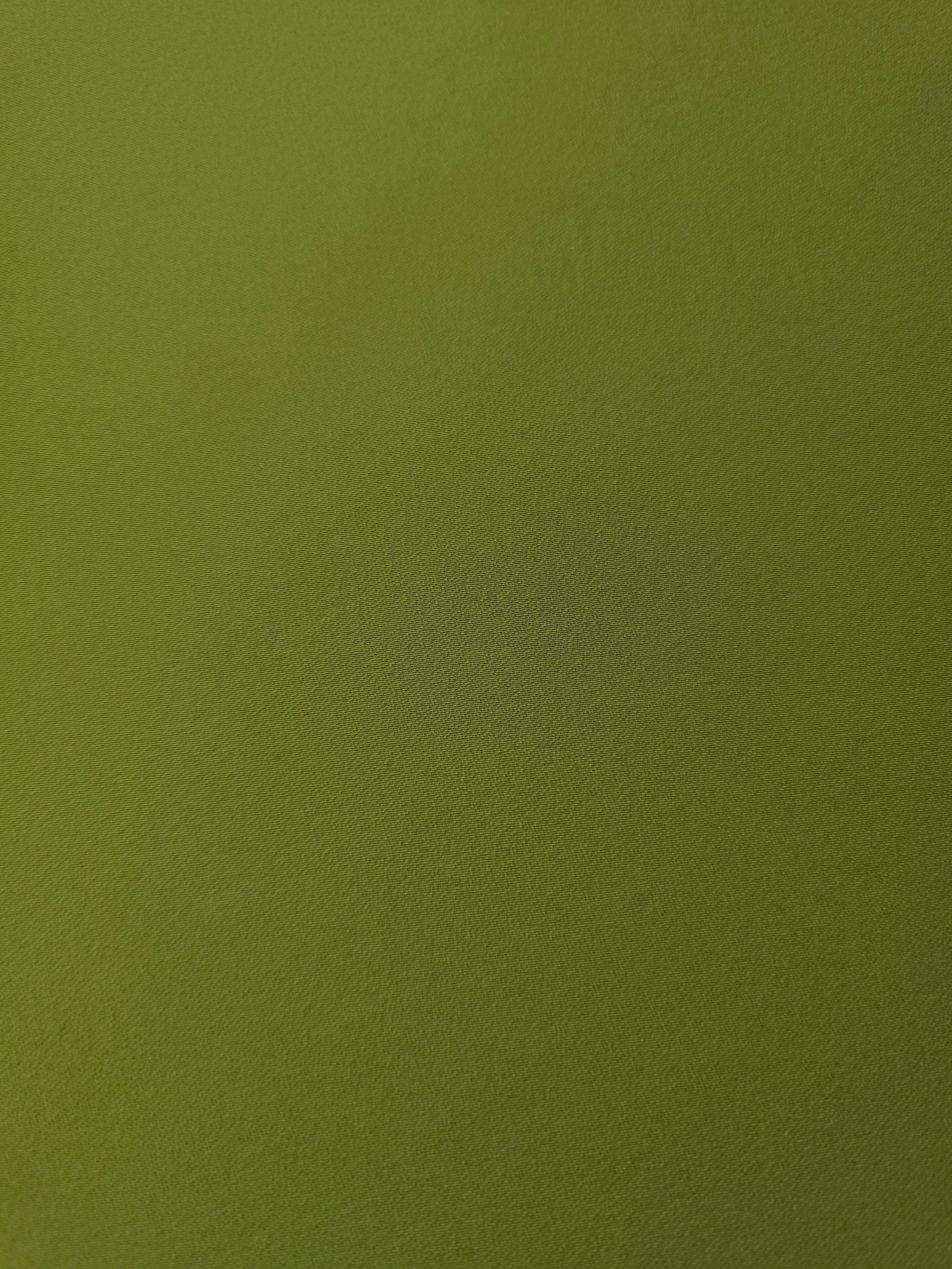 Texture detail of Moss Green mechanical polyester crepe, a smooth woven fabric with a soft silky hand