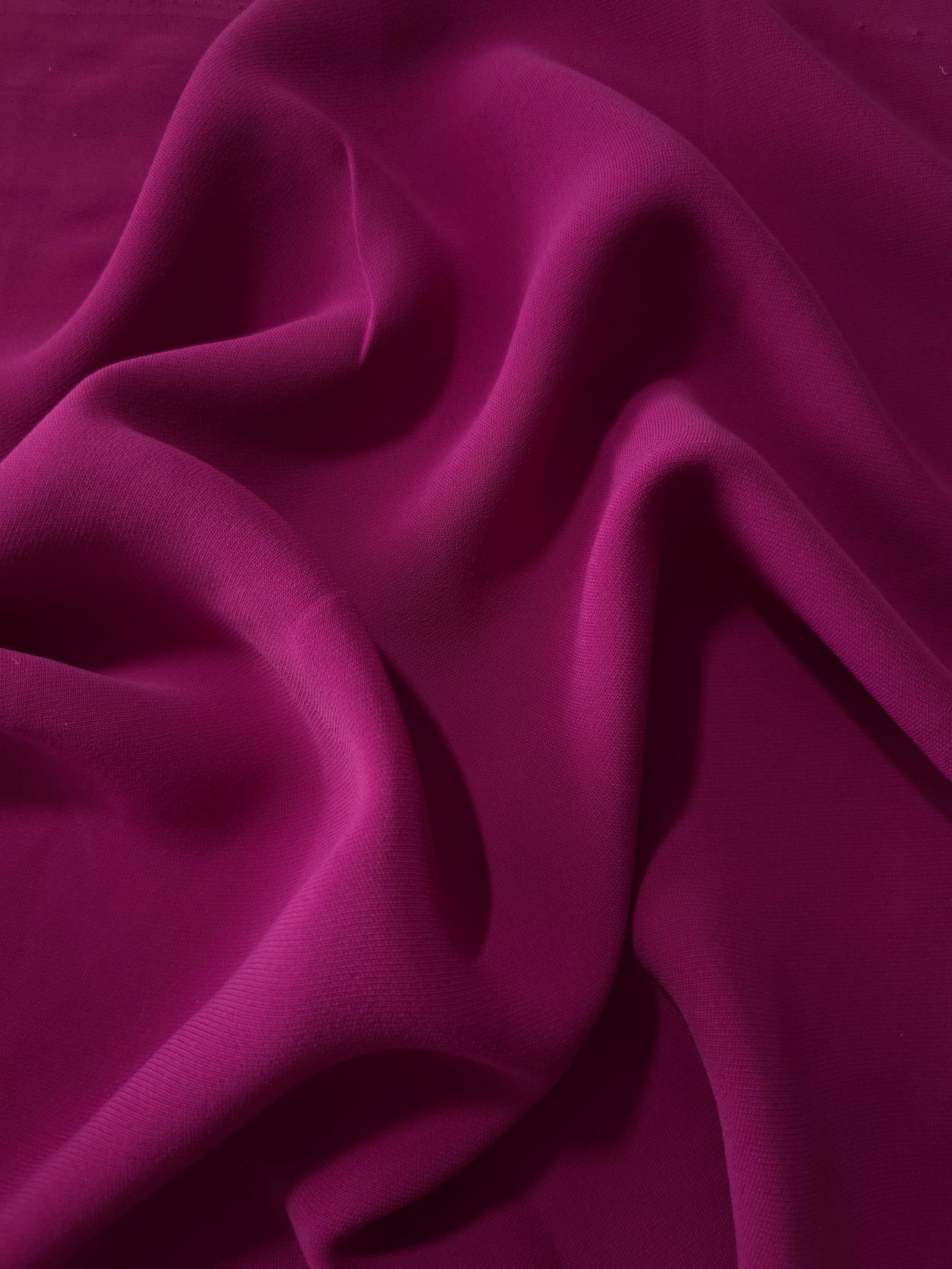 Draped Mulberry Purple Korean polyester crepe showing opaque fluid folds for evening dresses and occasionwear