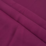 Layered Mulberry Purple mechanical polyester crepe showing soft structure and slight mechanical stretch for tailoring