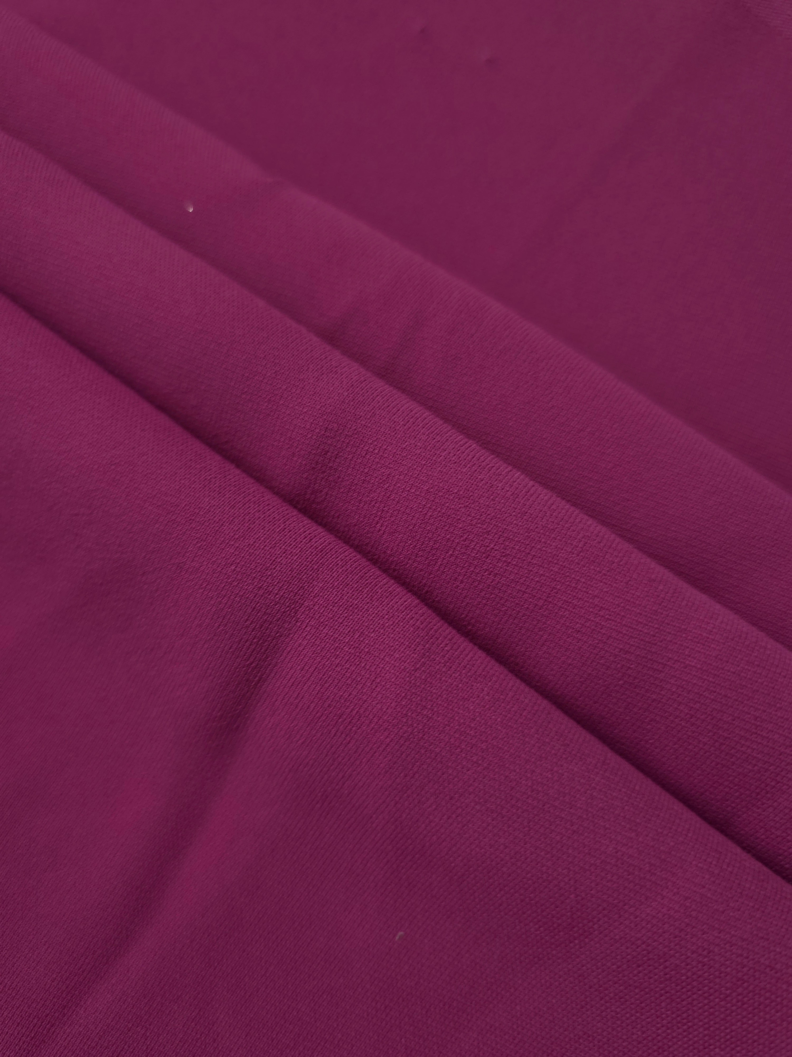 Layered Mulberry Purple mechanical polyester crepe showing soft structure and slight mechanical stretch for tailoring
