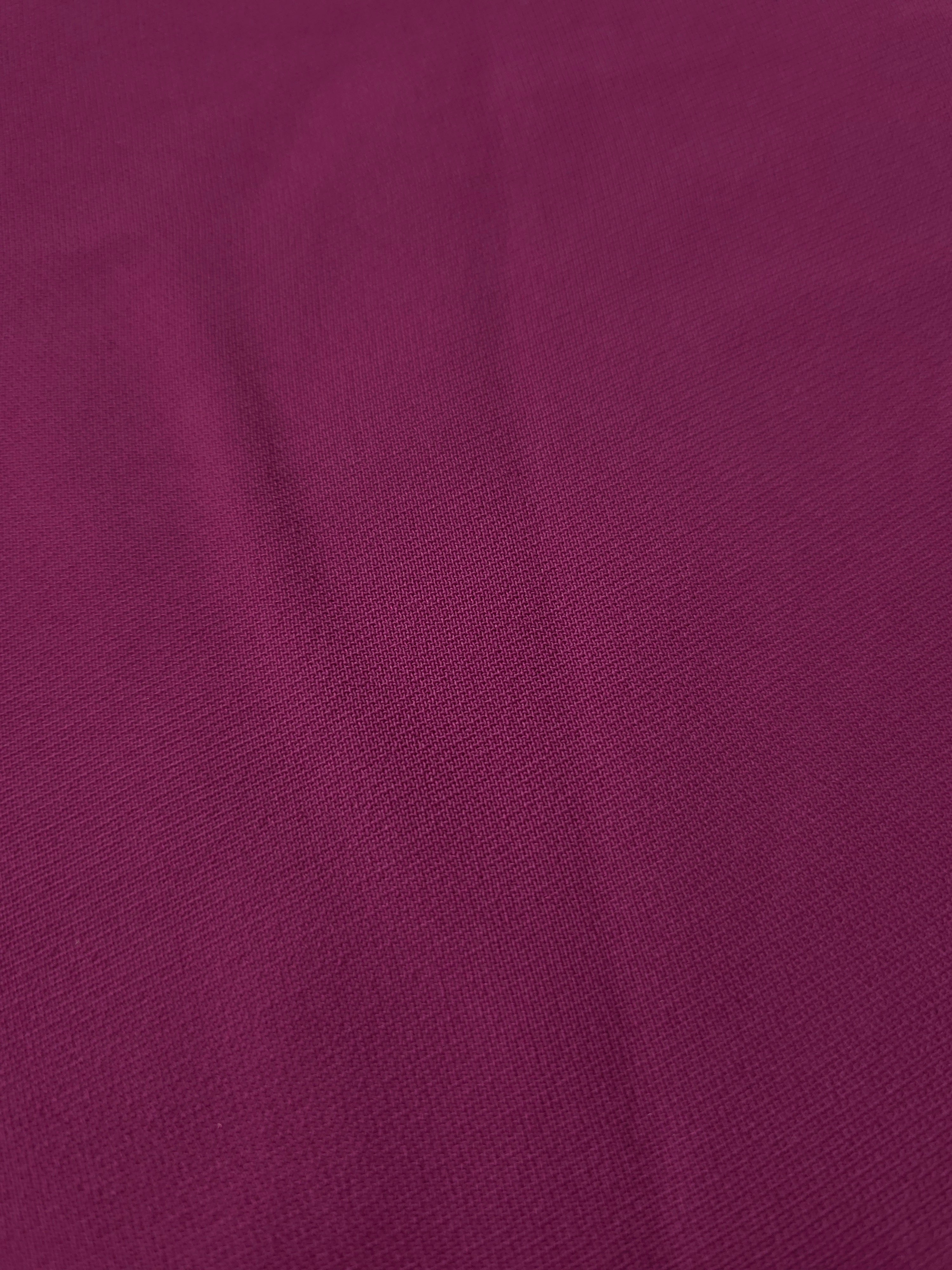 Close-up of Mulberry Purple 100% mechanical polyester crepe showing fine woven texture and a silky-soft hand feel
