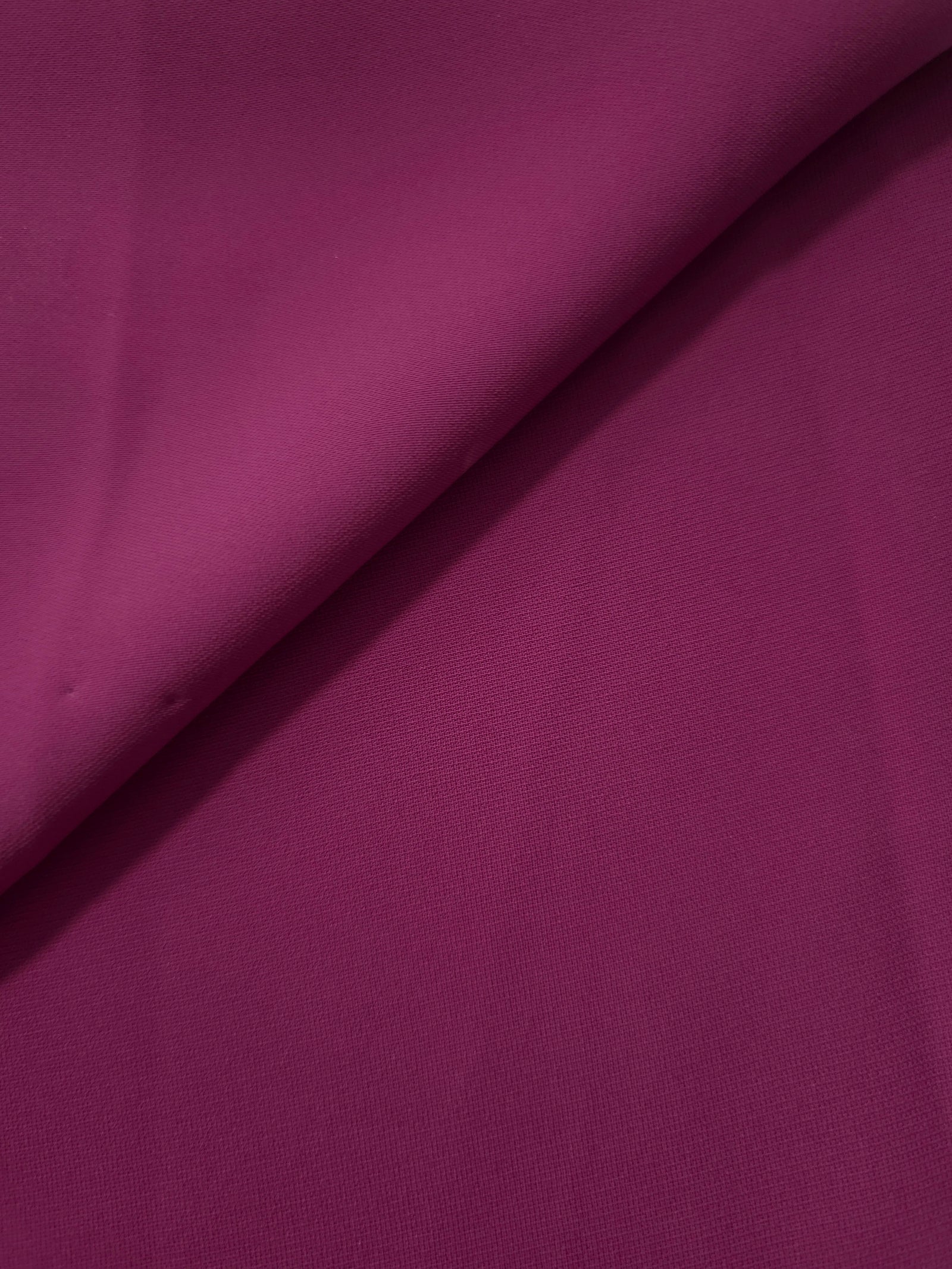 Mulberry Purple Korean polyester crepe in a soft fold, showing fluid drape for blouses and flowing dresses
