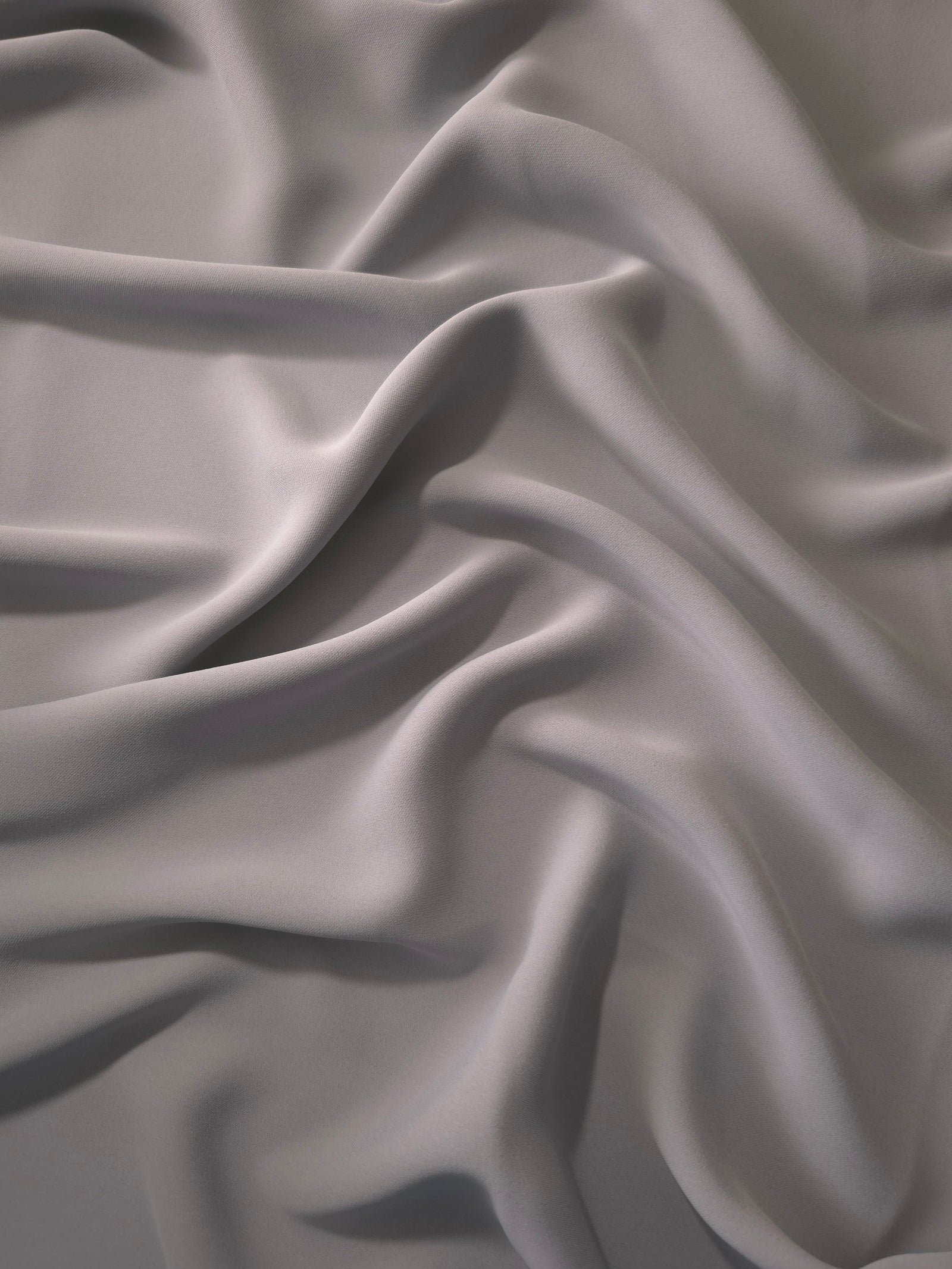 Draped Mushroom Greige Korean polyester crepe showing opaque fluid folds for evening dresses and occasionwear