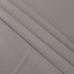 Layered Mushroom Greige mechanical polyester crepe showing soft structure and slight mechanical stretch for tailoring
