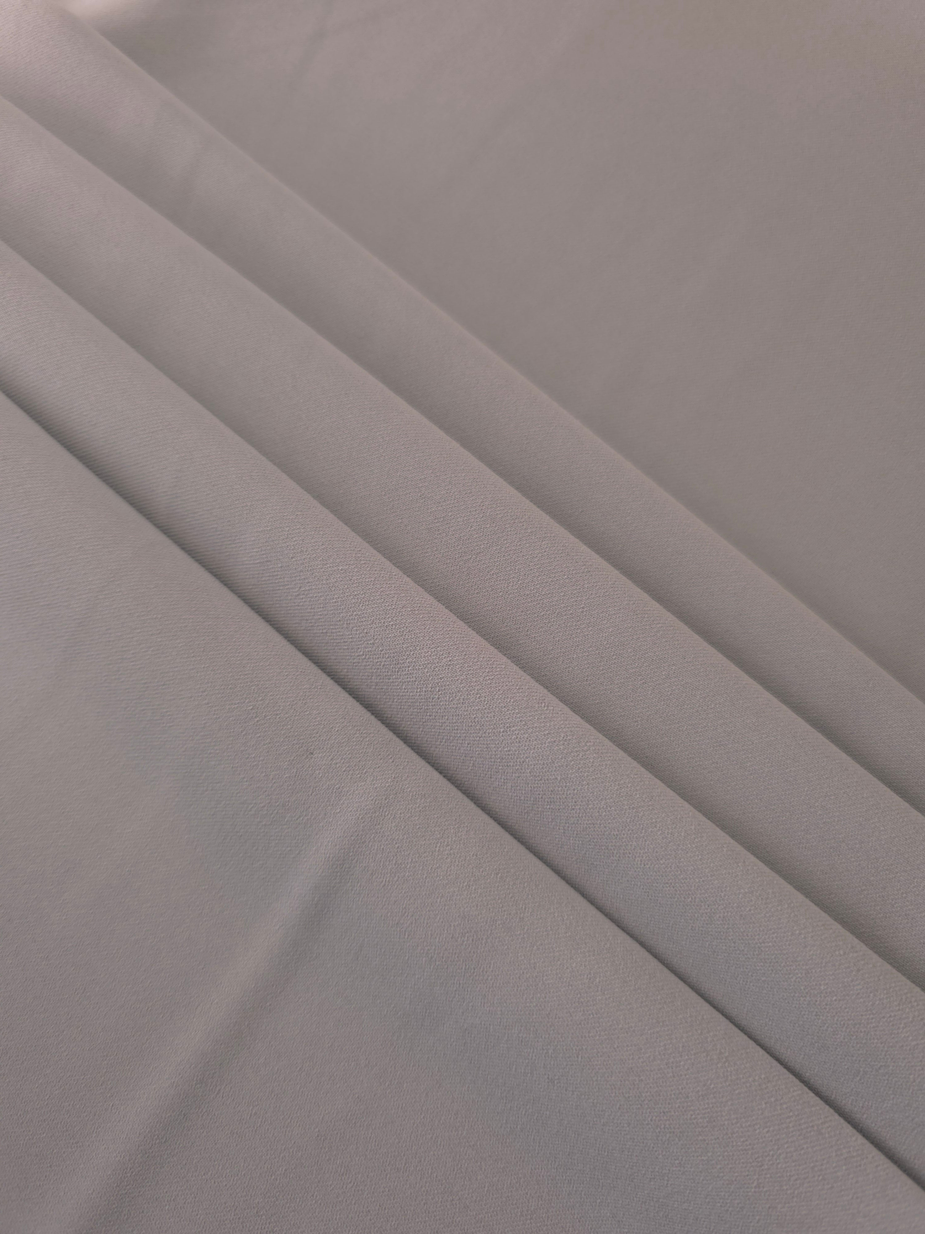 Layered Mushroom Greige mechanical polyester crepe showing soft structure and slight mechanical stretch for tailoring