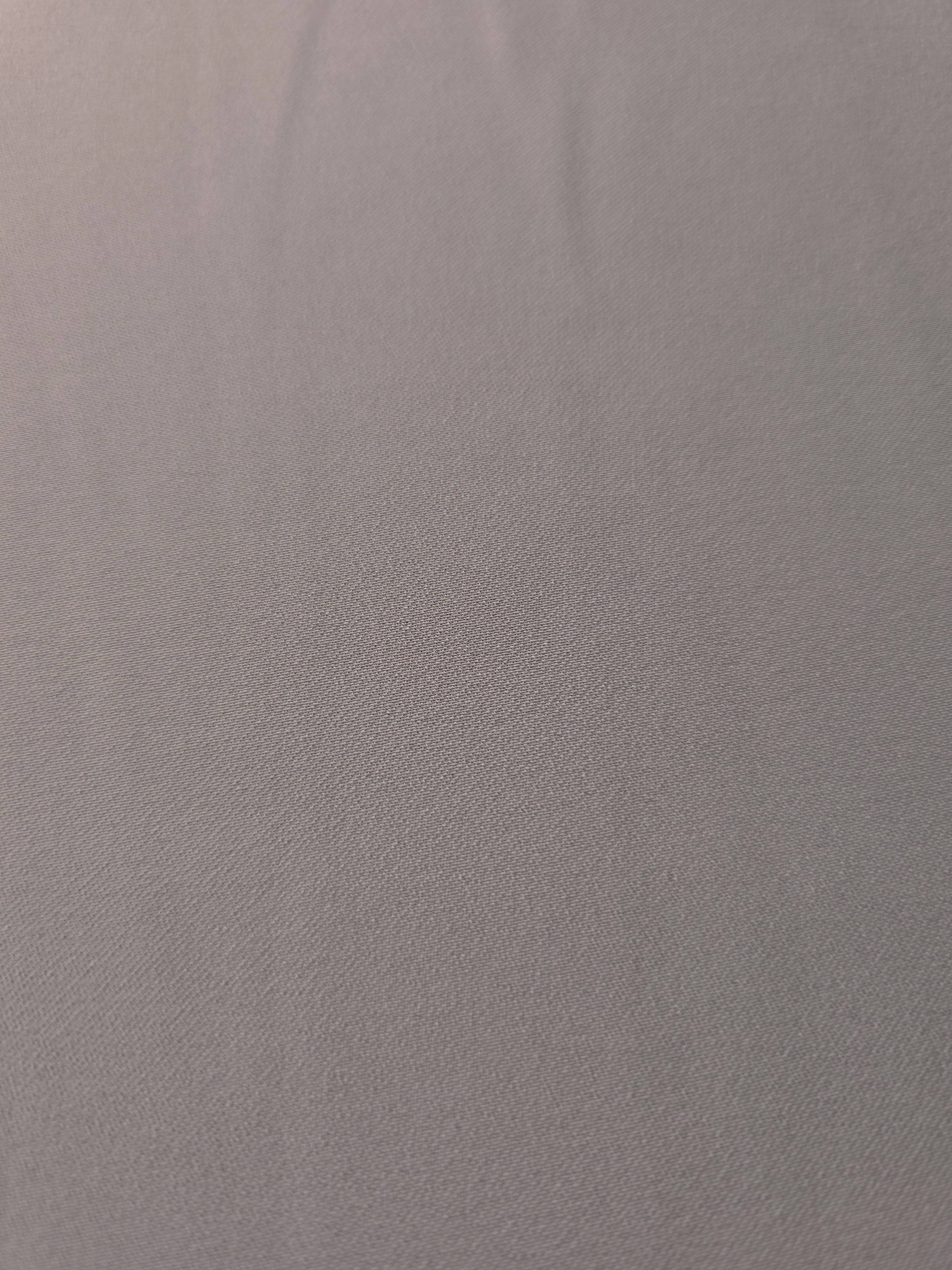Close-up of Mushroom Greige 100% mechanical polyester crepe showing fine woven texture and a silky-soft hand feel