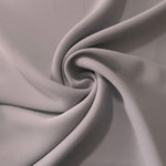 Mushroom Greige polyester crepe arranged in a flowing swirl, showing drape used for abayas and modest fashion