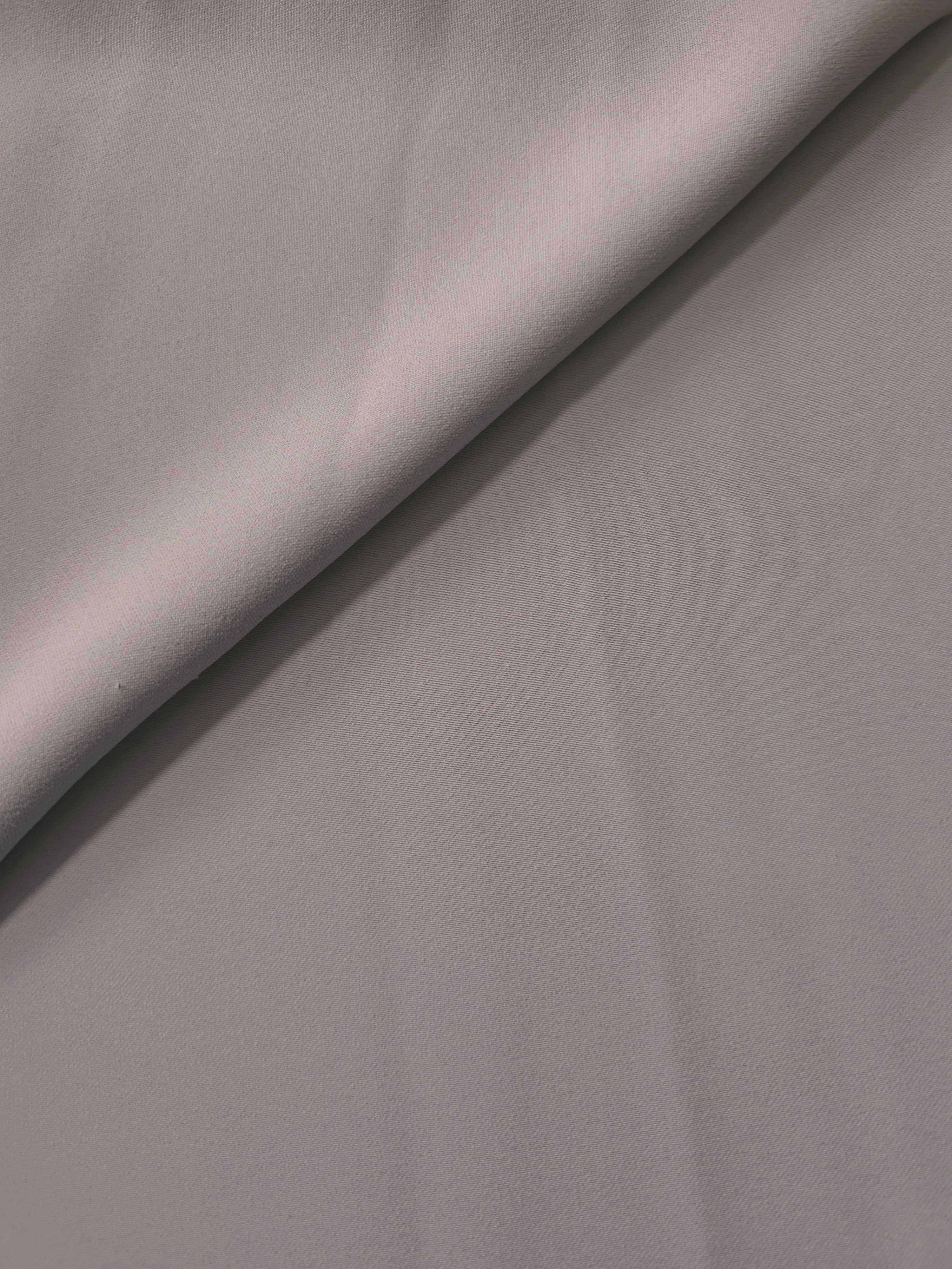 Mushroom Greige Korean polyester crepe in a soft fold, showing fluid drape for blouses and flowing dresses