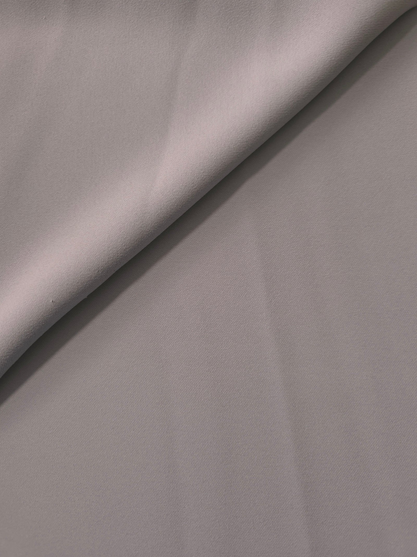 Mushroom Greige Korean polyester crepe in a soft fold, showing fluid drape for blouses and flowing dresses