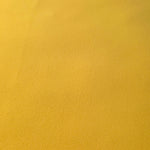 Close-up of Mustard Yellow 100% mechanical polyester crepe showing fine woven texture and a silky-soft hand feel