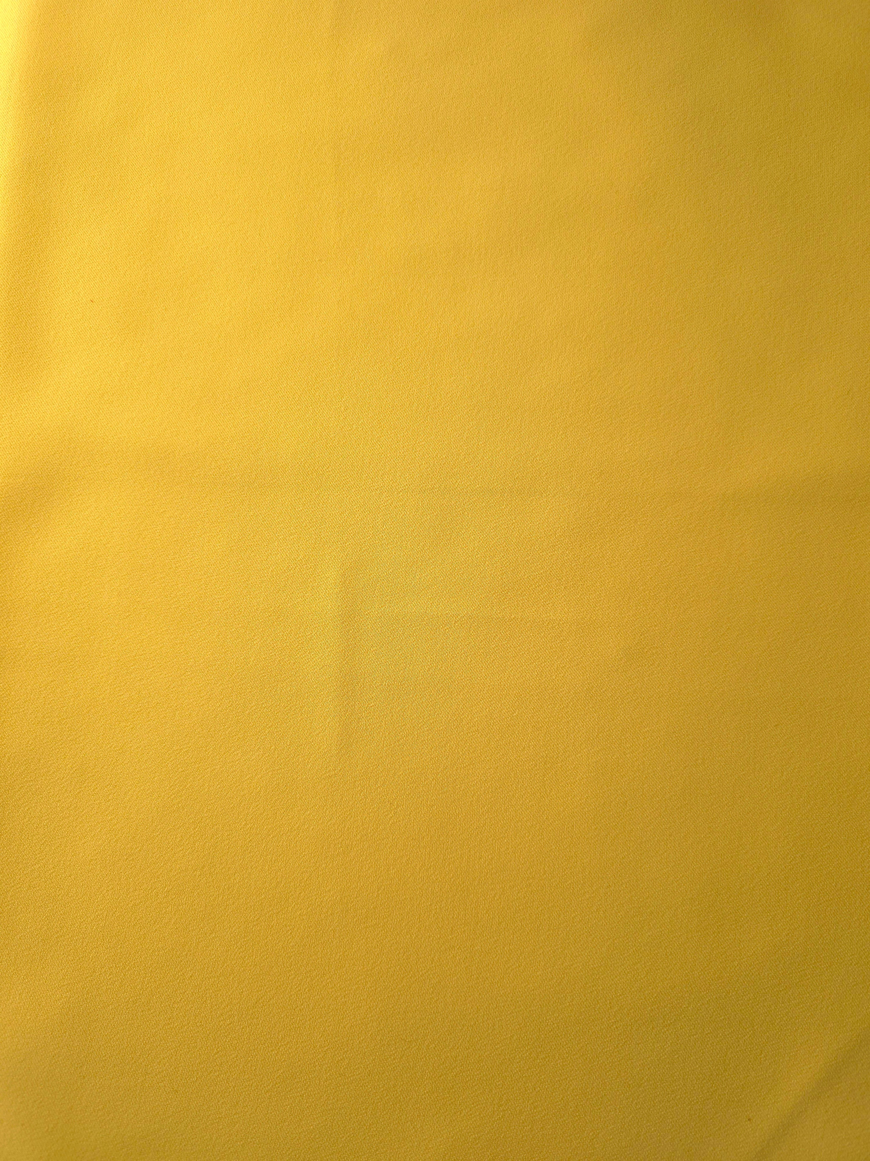 Mustard Yellow 205 GSM Korean polyester crepe shown flat, an opaque smooth woven dress fabric with a silky-soft finish