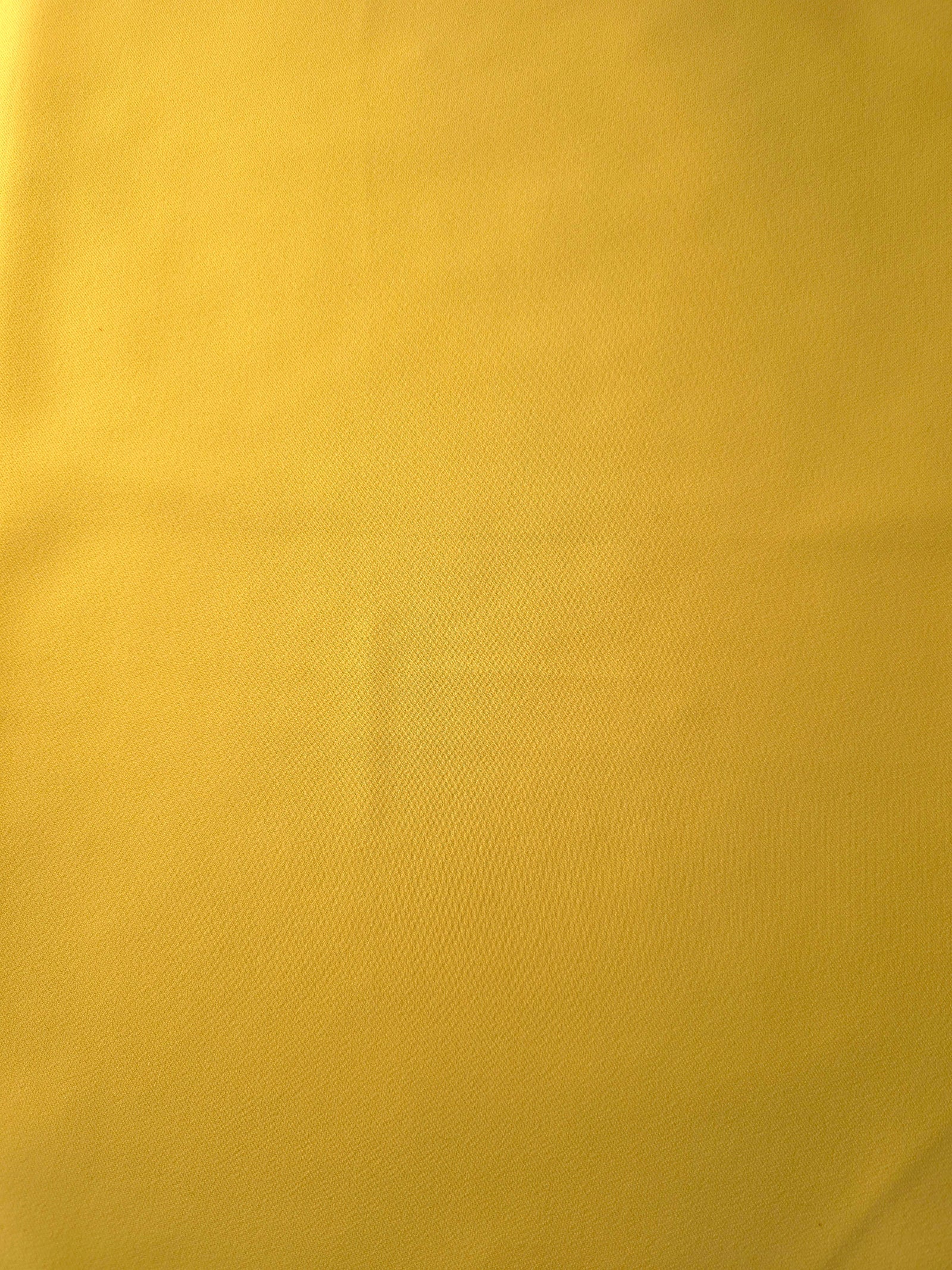 Mustard Yellow 205 GSM Korean polyester crepe shown flat, an opaque smooth woven dress fabric with a silky-soft finish