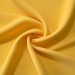Mustard Yellow polyester crepe arranged in a flowing swirl, showing drape used for abayas and modest fashion