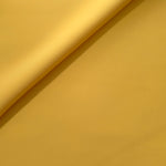 Mustard Yellow Korean polyester crepe in a soft fold, showing fluid drape for blouses and flowing dresses