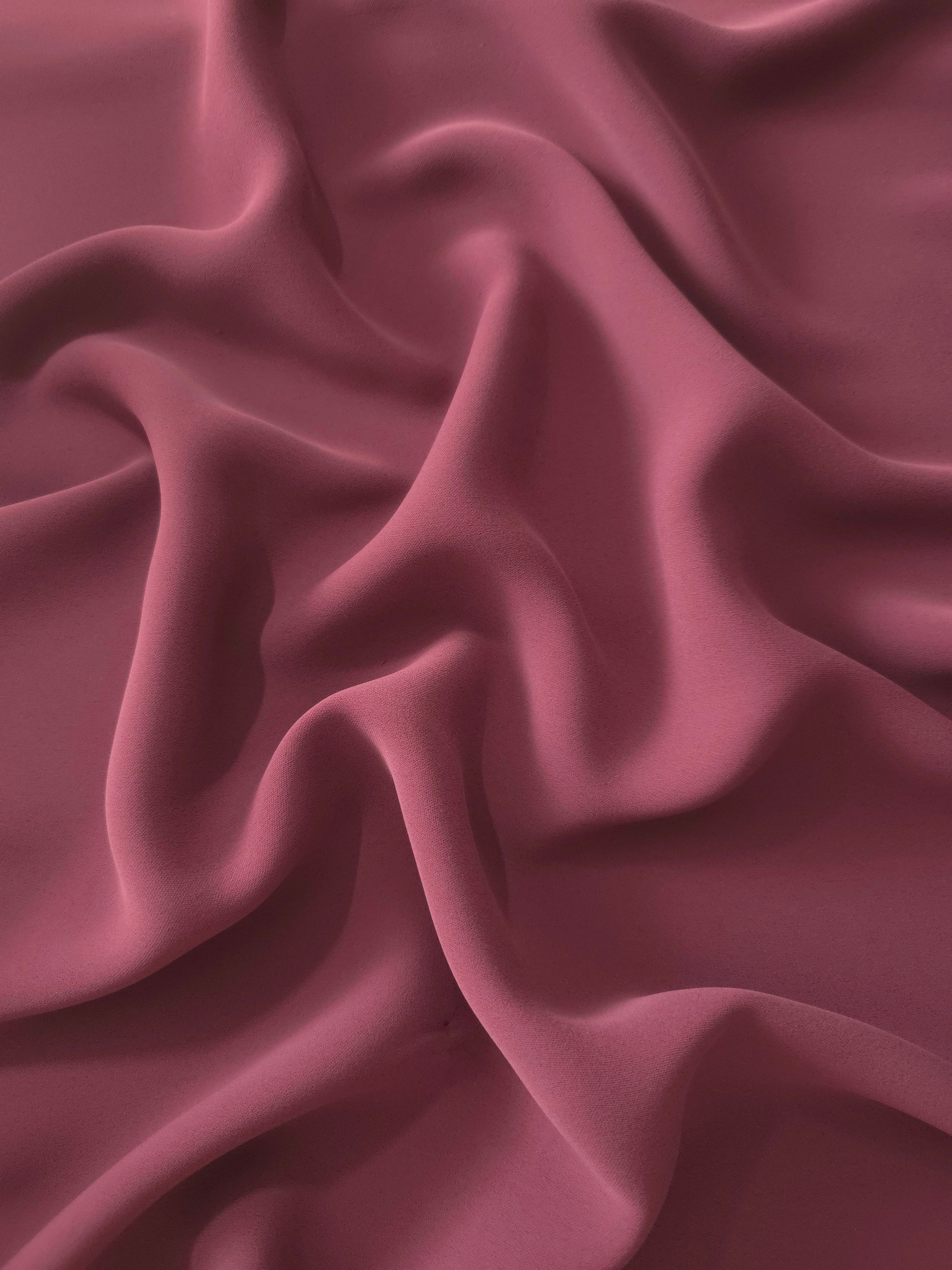 Long draped folds of Muted Wine Red polyester crepe showing flowing coverage for abayas, dresses and modest wear