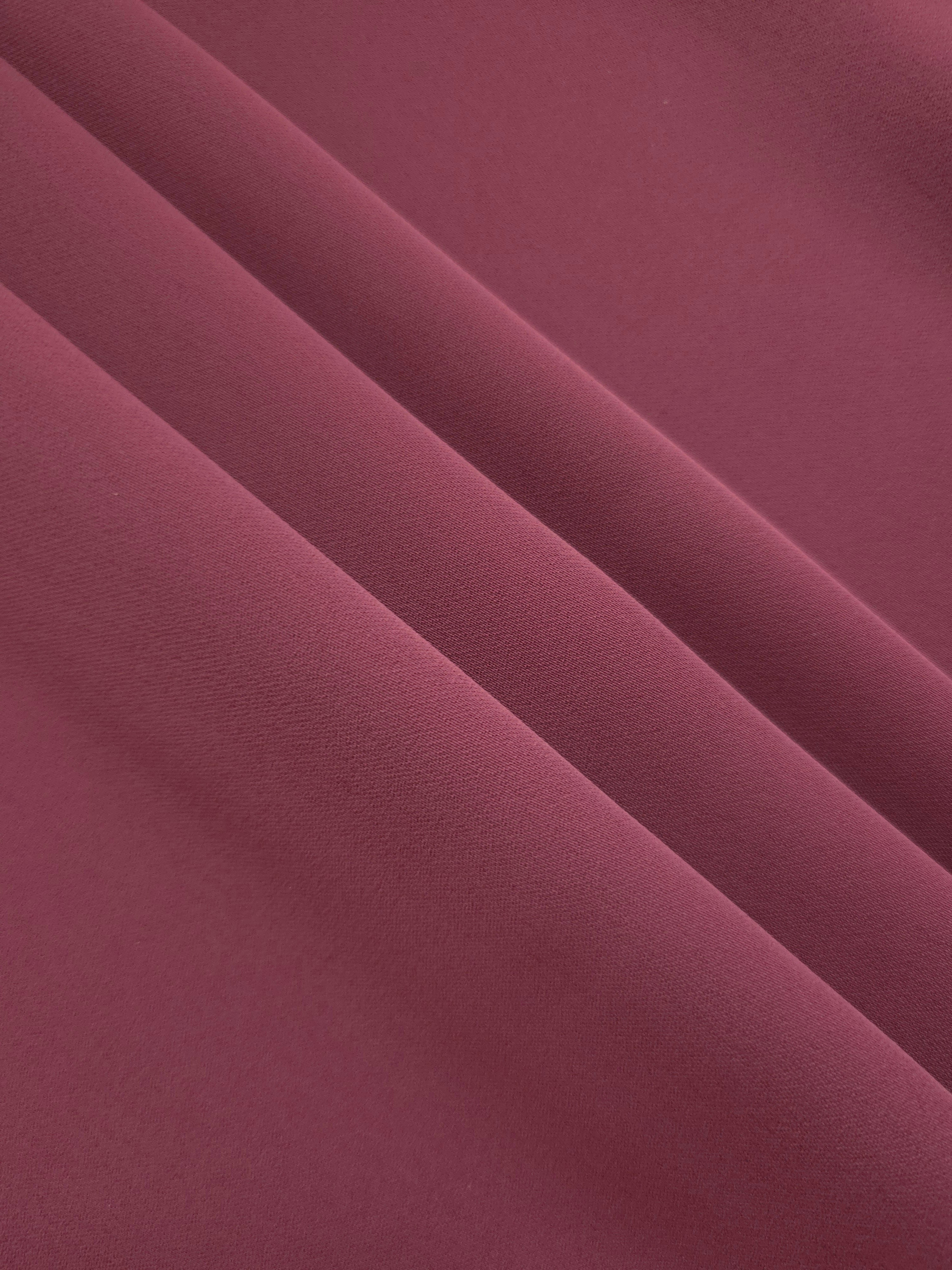 Layered Muted Wine Red polyester crepe showing soft body and gentle mechanical stretch for light tailoring