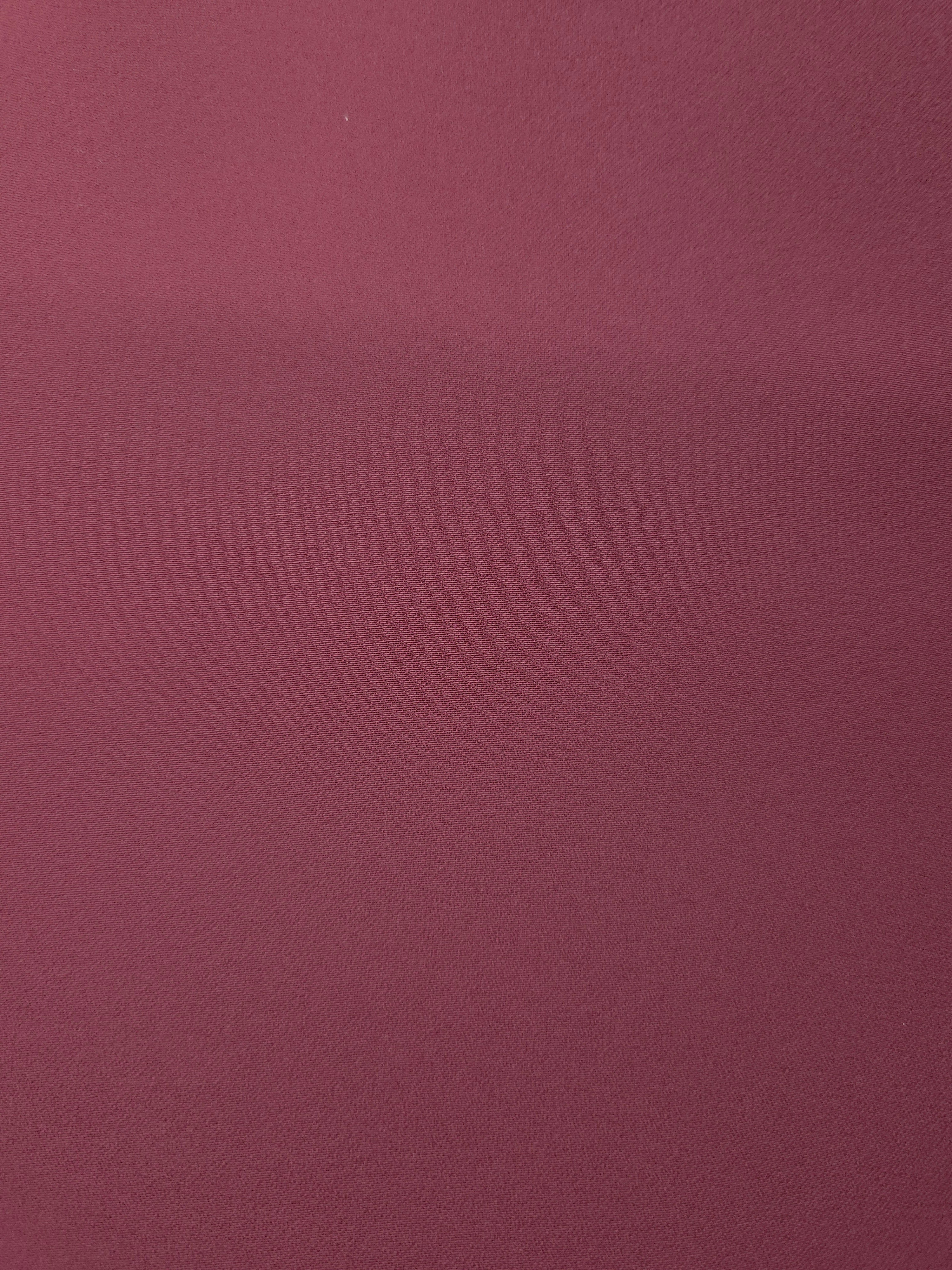 Fine texture close-up of Muted Wine Red mechanical polyester crepe showing a smooth, silky-soft woven hand