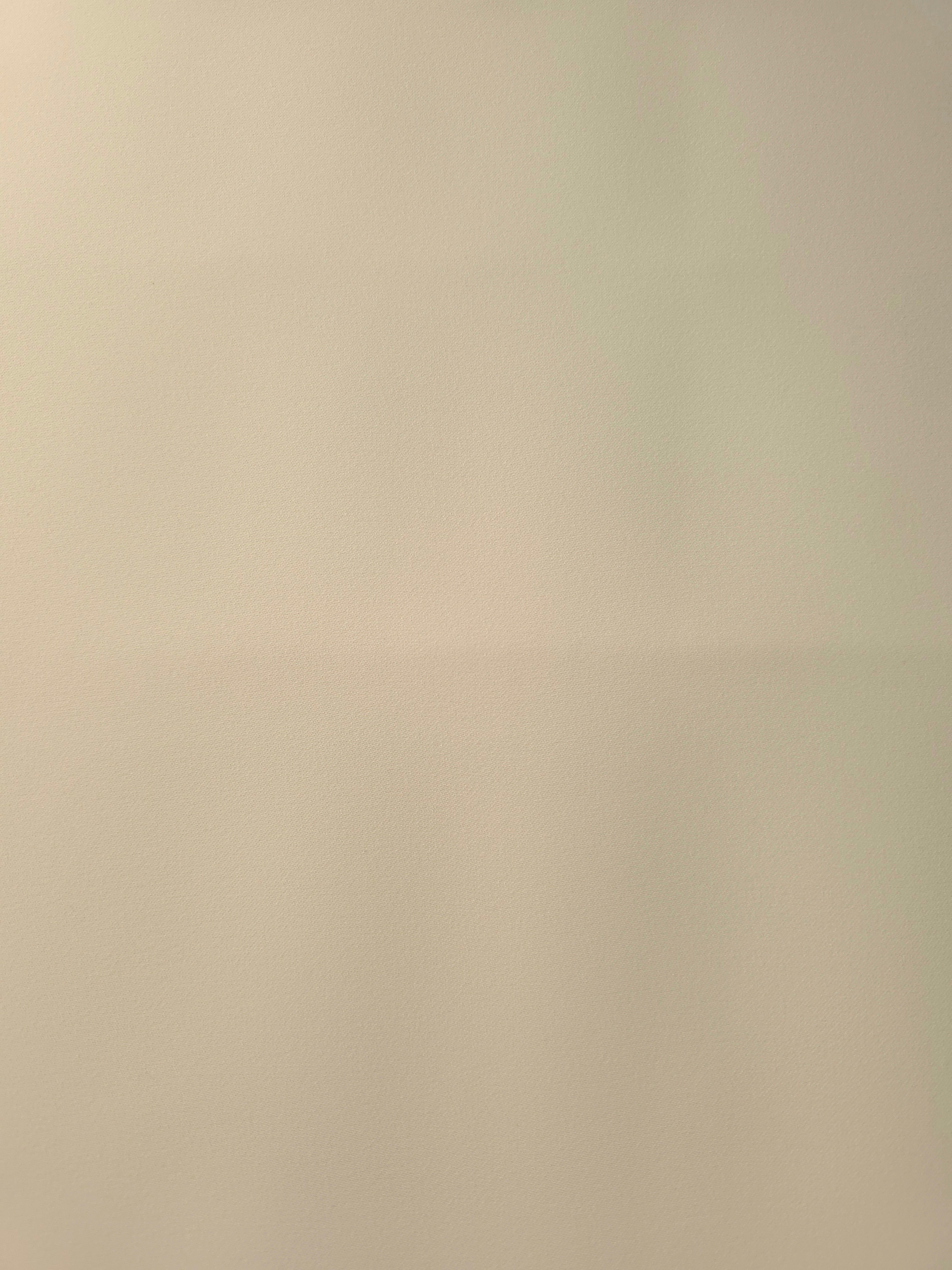 Flat lay of Oatmeal Beige polyester crepe, smooth Italian-style apparel fabric with a soft refined finish